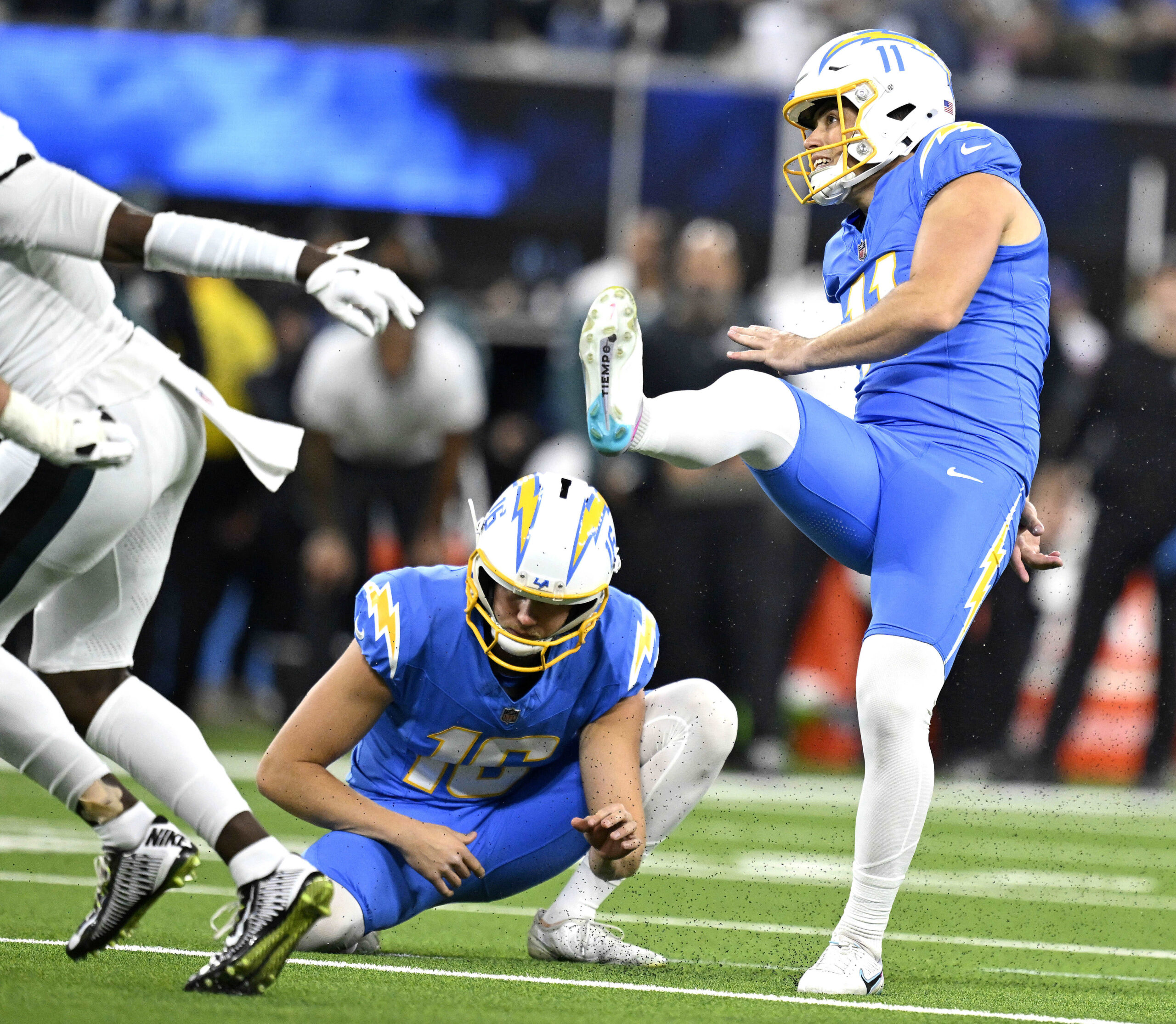 Chargers kicker Cameron Dicker, right, kicks one of his five...