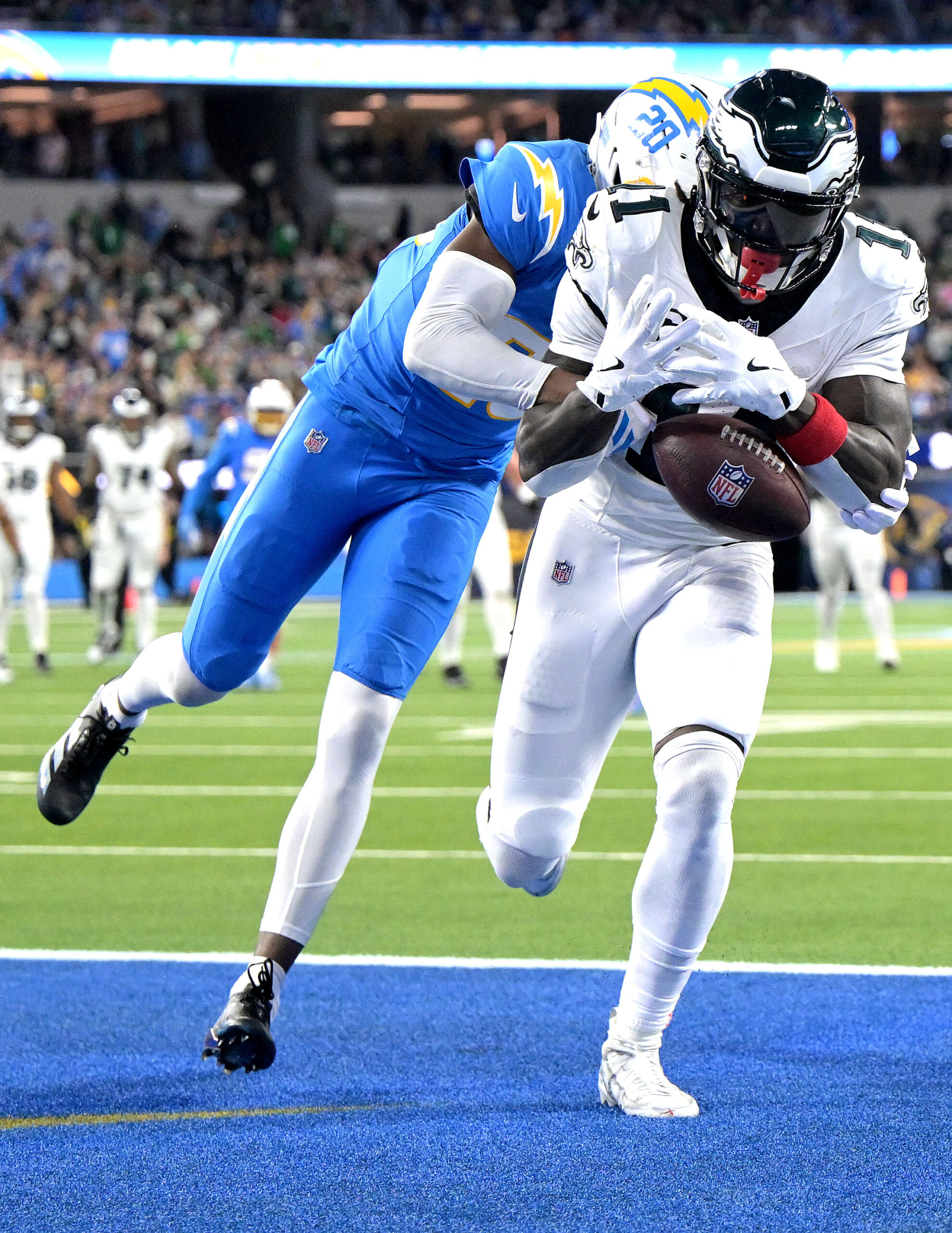 Chargers cornerback Cam Hart, left, defends as Philadelphia Eagles wide...