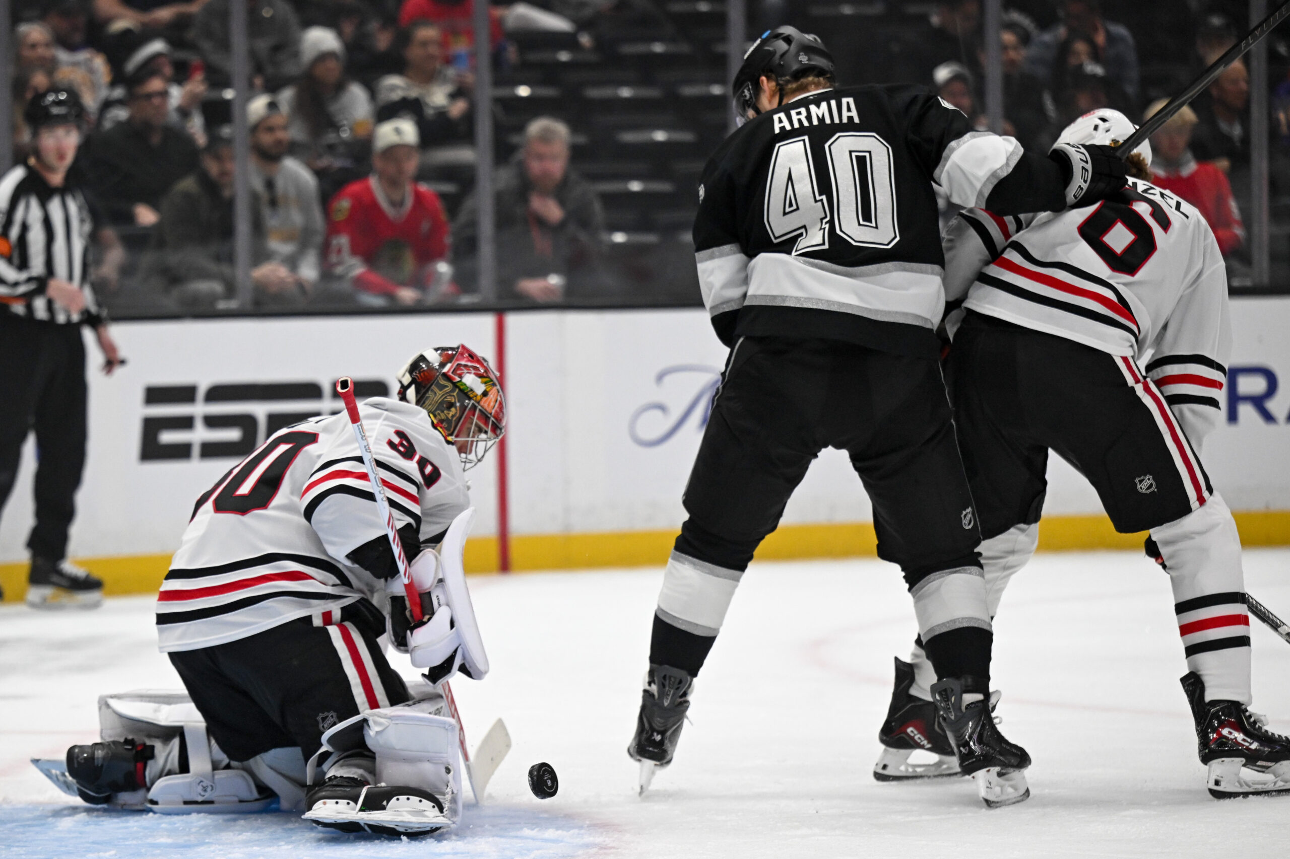 Backhawks Spencer Knight (30) blocks a shot by Kings Joel...