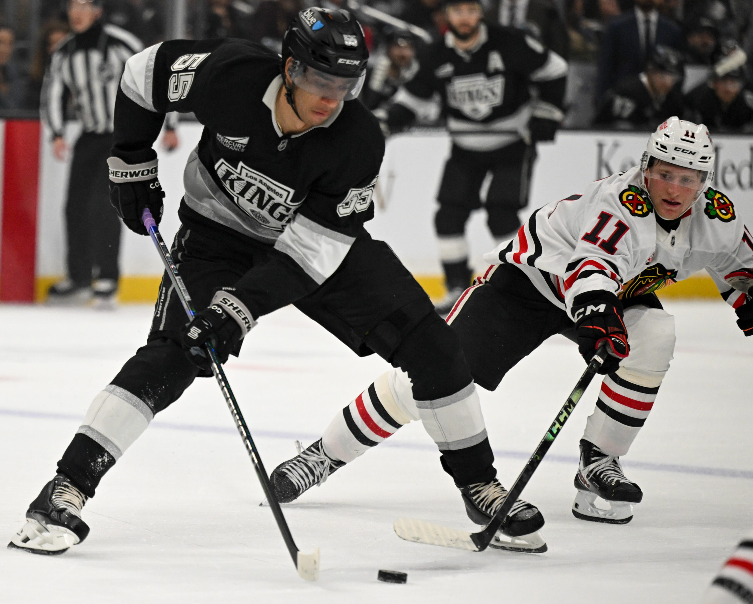 The Kings’ Quinton Byfield, left, battles the Chicago Backhawks’ Oliver...