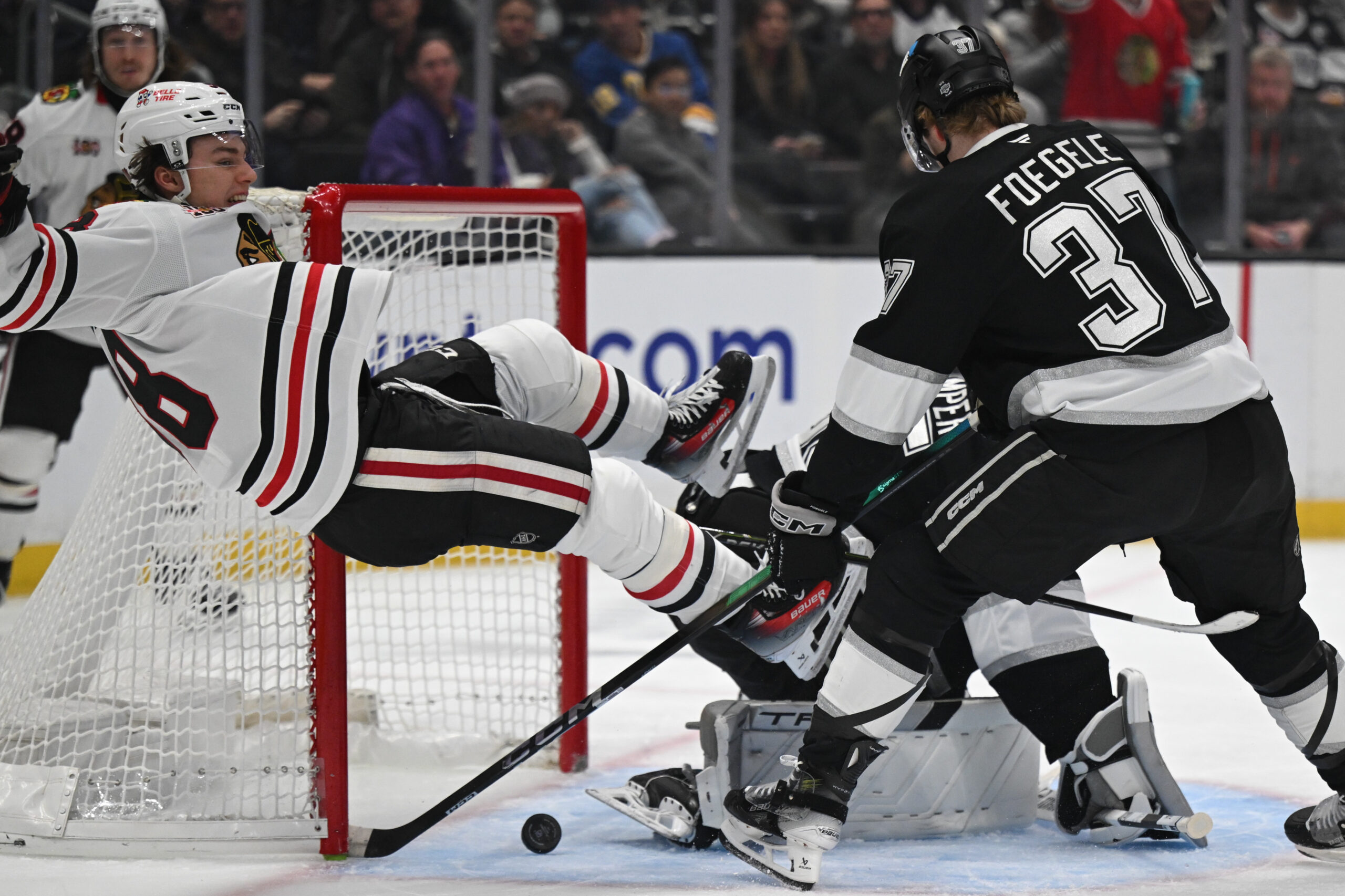 Blackhawks Connor Bedard (98) flys over the net as he...