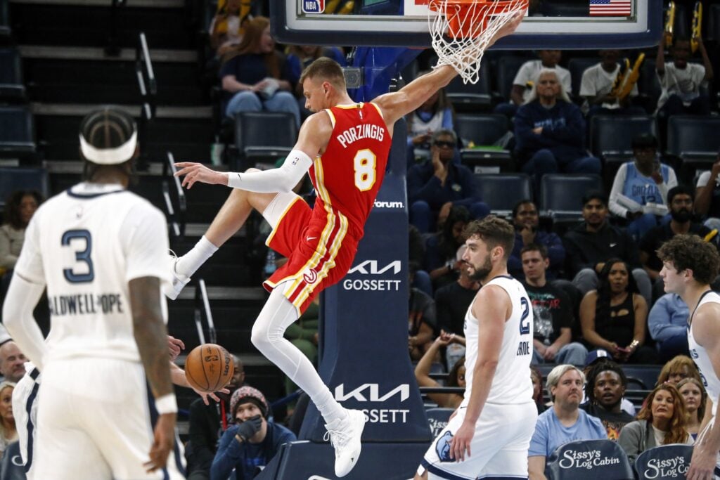 Oct 11, 2025; Memphis, Tennessee, USA; Atlanta Hawks center Kristaps Porzingis (8) dunks during the third quarter against the Memphis Grizzlies at FedExForum. Mandatory Credit: Petre Thomas-Imagn Images