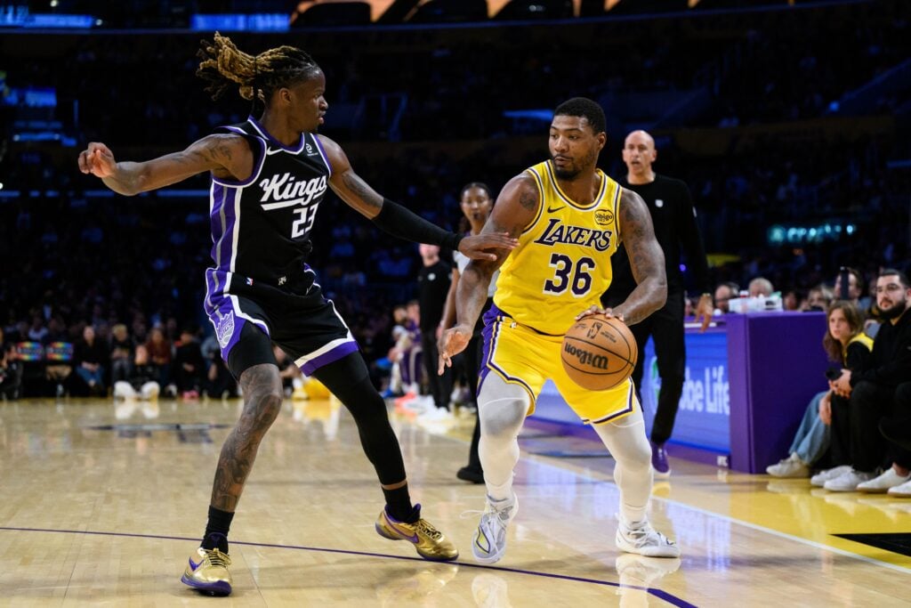 Oct 17, 2025; Los Angeles, California, USA; Los Angeles Lakers guard Marcus Smart (36) controls the ball under pressure from Sacramento Kings guard Keon Ellis (23) during the second half at Crypto.com Arena. Mandatory Credit: William Liang-Imagn Images