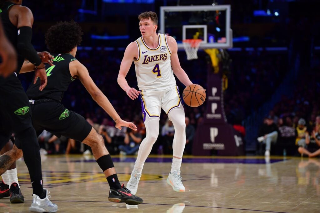 Nov 30, 2025; Los Angeles, California, USA; Los Angeles Lakers forward Dalton Knecht (4) controls the ball against the New Orleans Pelicans during the first half at Crypto.com Arena. Mandatory Credit: Gary A. Vasquez-Imagn Images