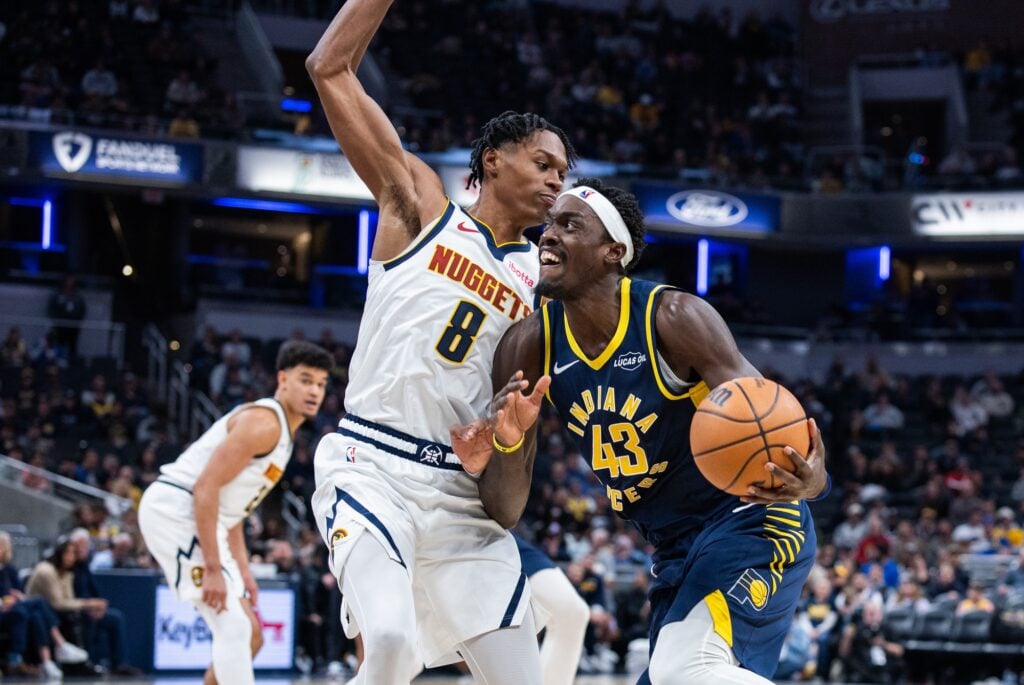 Indiana Pacers forward Pascal Siakam (43) dribbels the ball while Denver Nuggets guard Peyton Watson (8) defends in the second half at Gainbridge Fieldhouse.