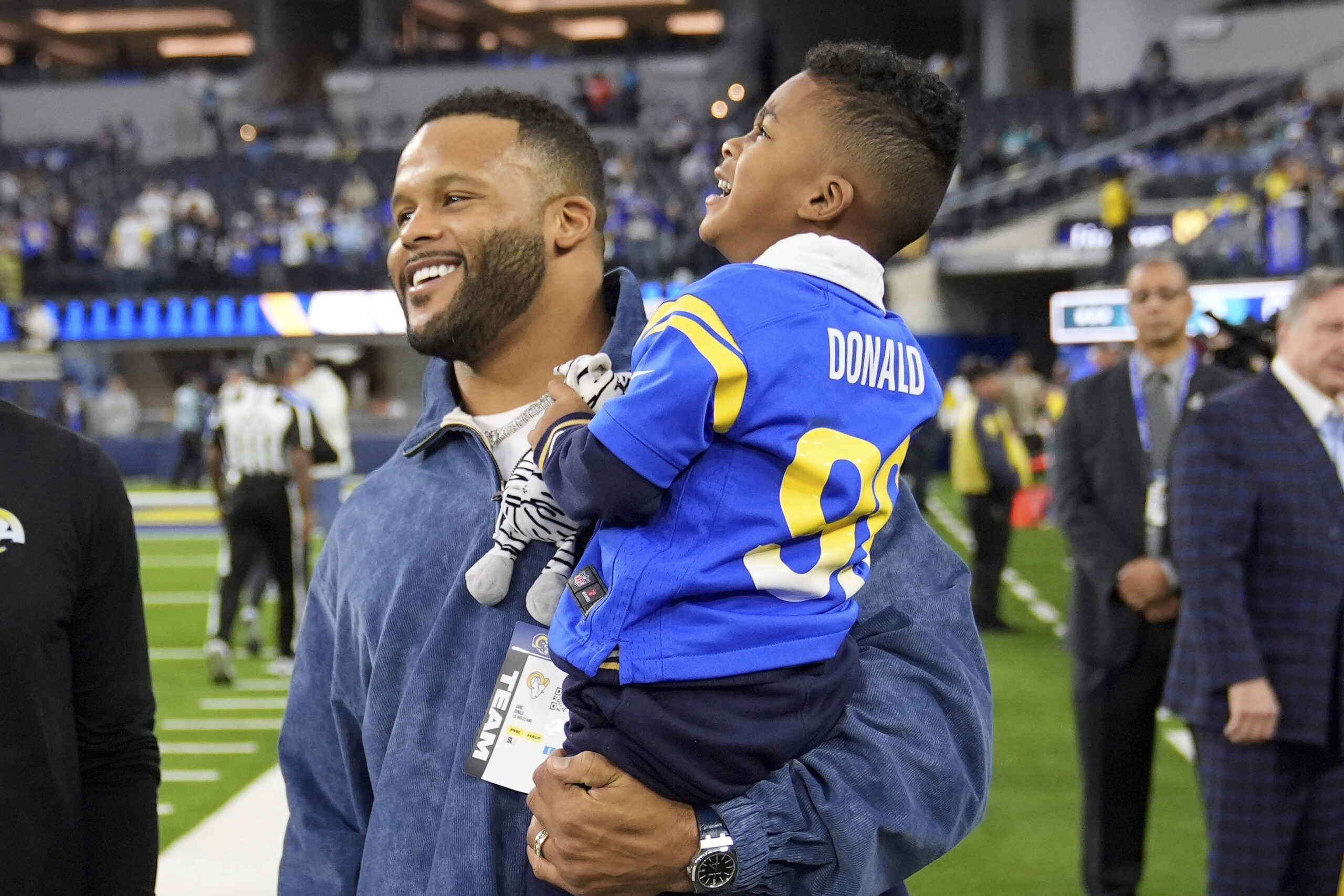 Former football player Aaron Donald holds his son Aaric prior...