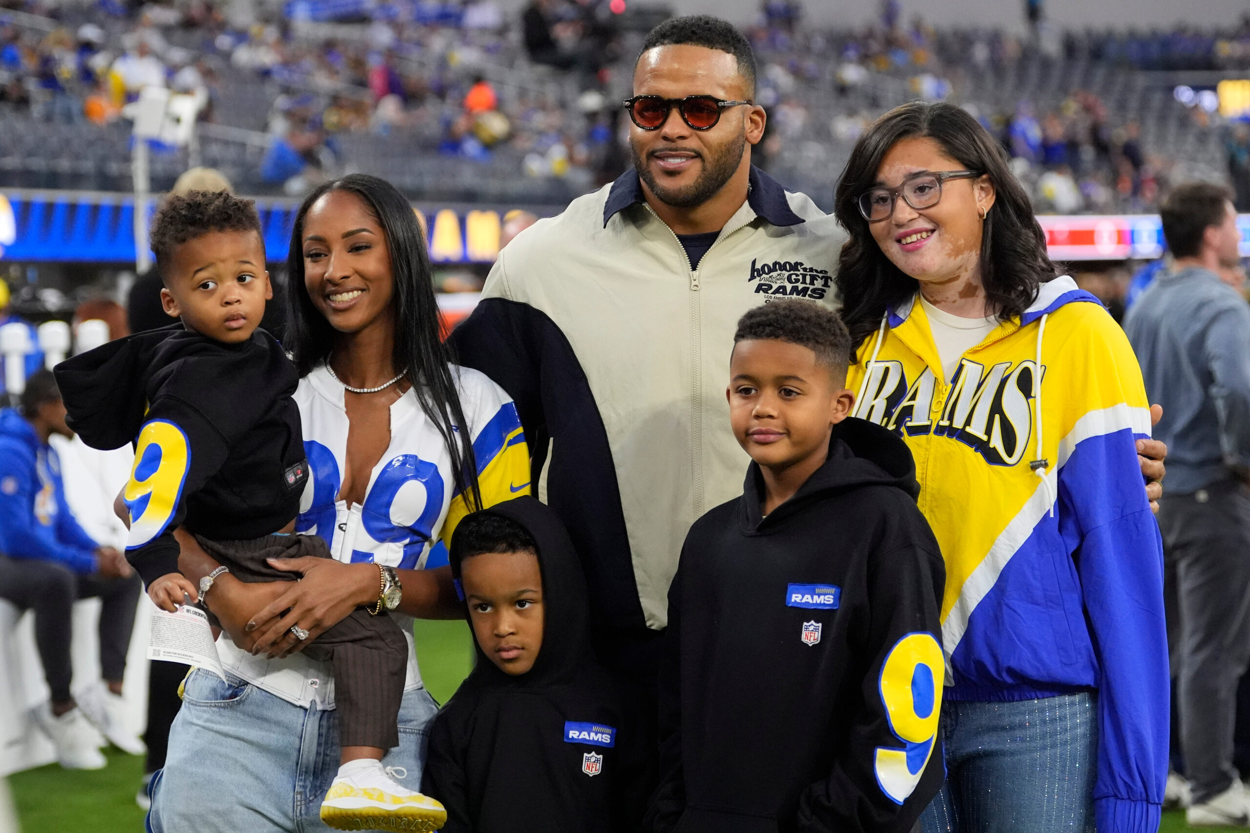 Rams former player Aaron Donald, center top, poses with his...