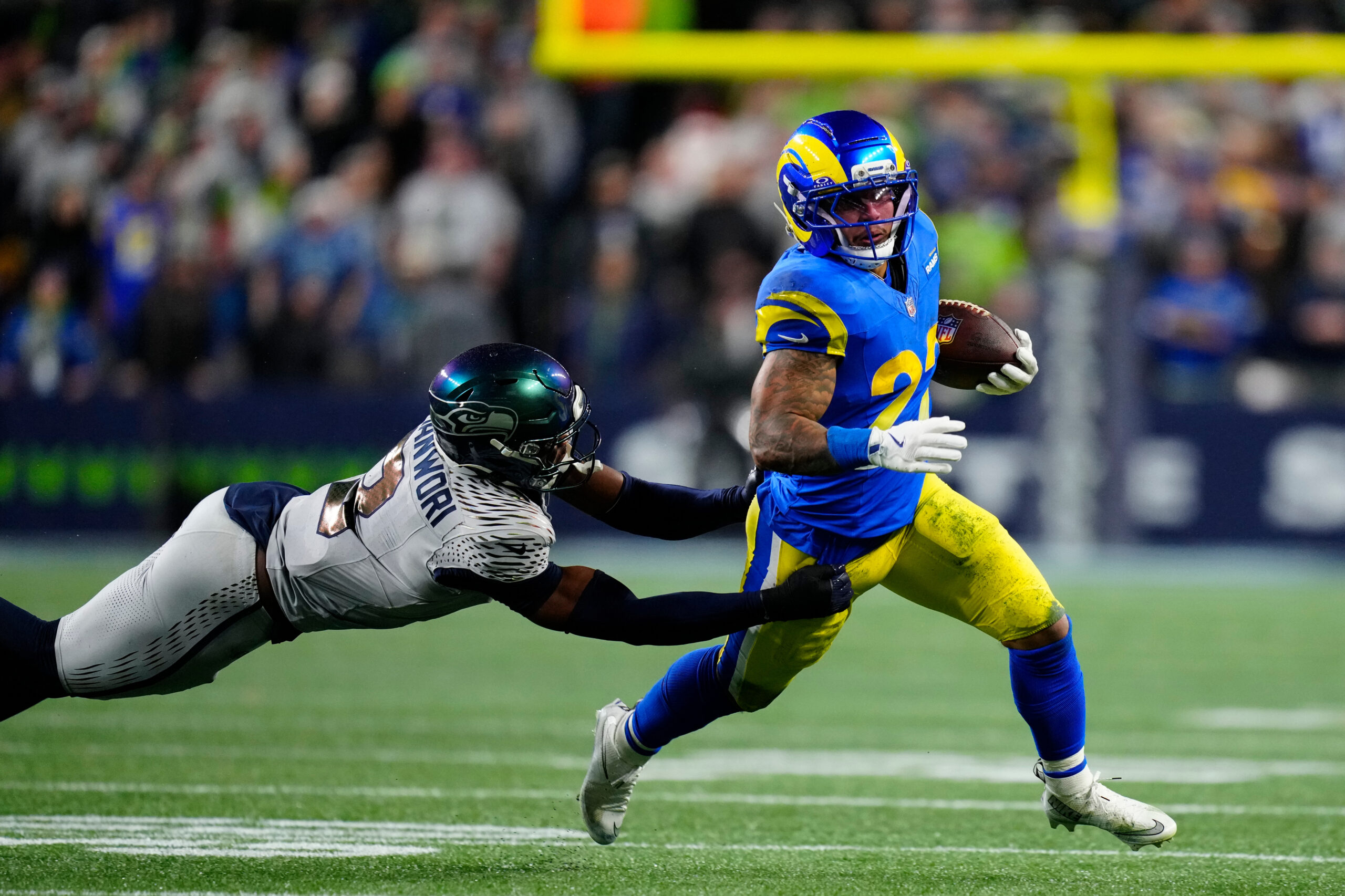 Seattle Seahawks safety Nick Emmanwori tries to grab Rams running...