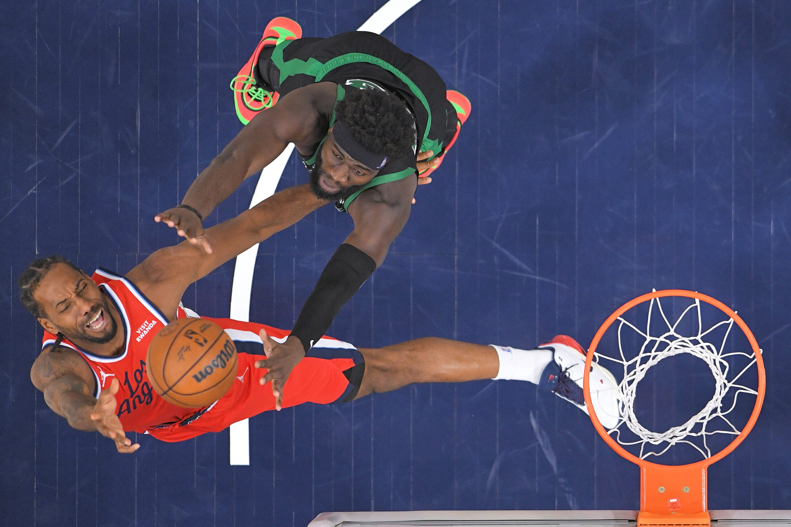 Clippers forward Kawhi Leonard, below, shoots as Boston Celtics center...