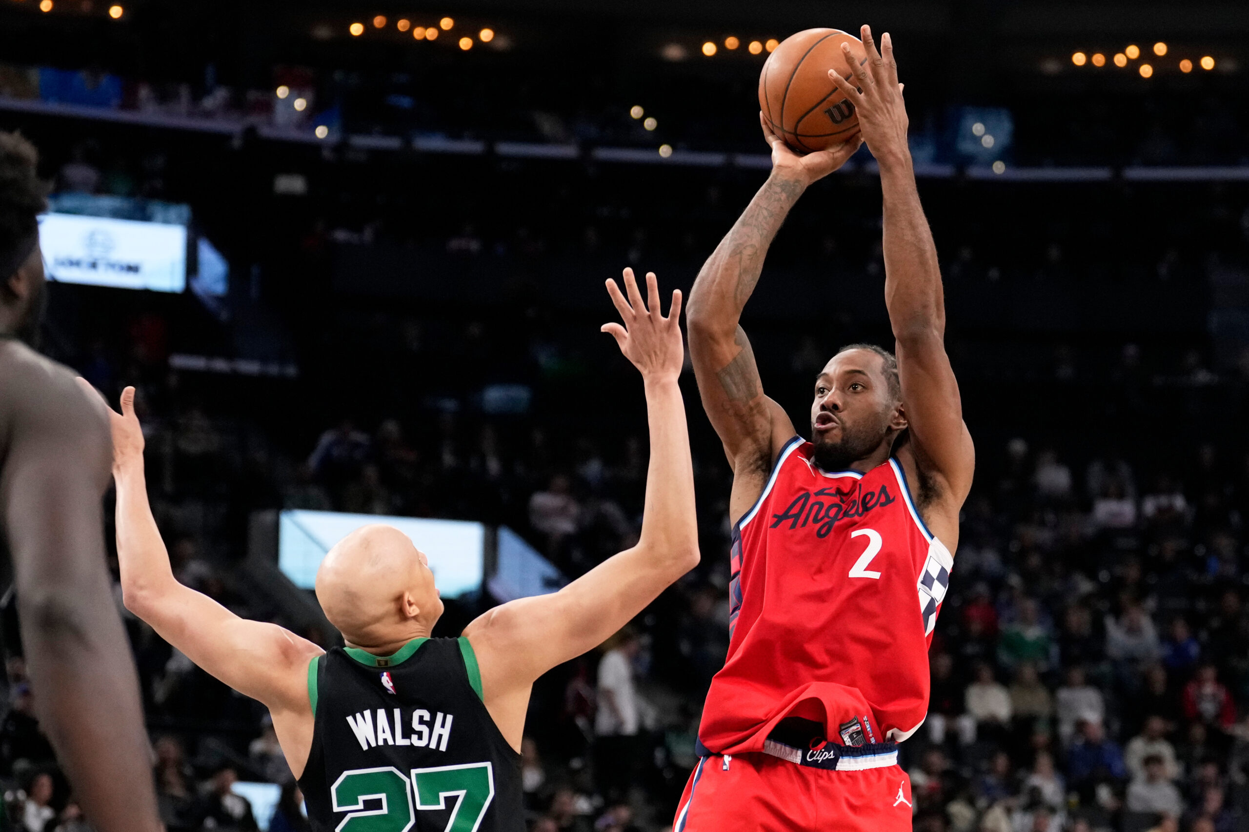 Clippers forward Kawhi Leonard, right, shoots as Boston Celtics guard...
