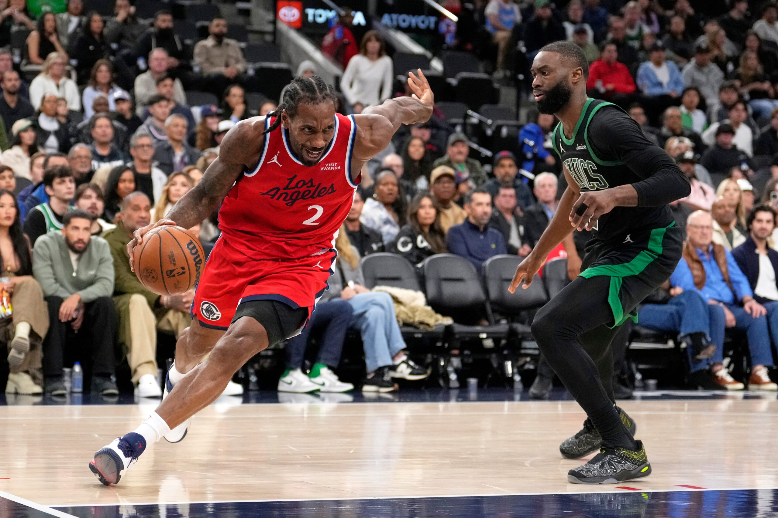 Clippers forward Kawhi Leonard, left, drives past Boston Celtics guard...