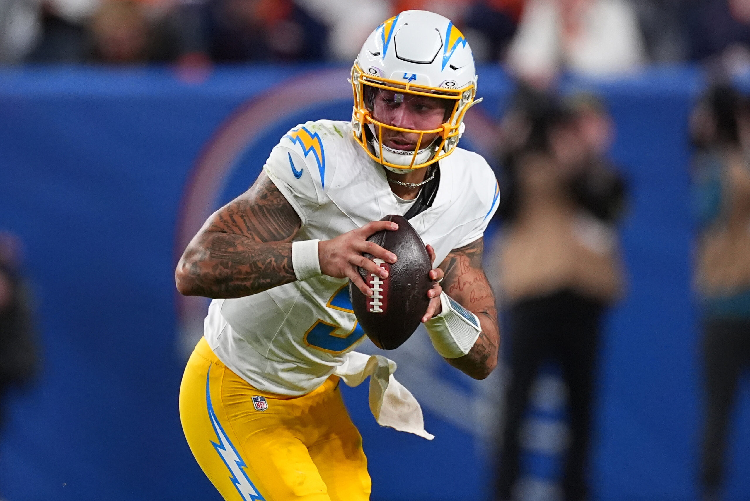 Chargers quarterback Trey Lance (5) runs against the Denver Broncos...