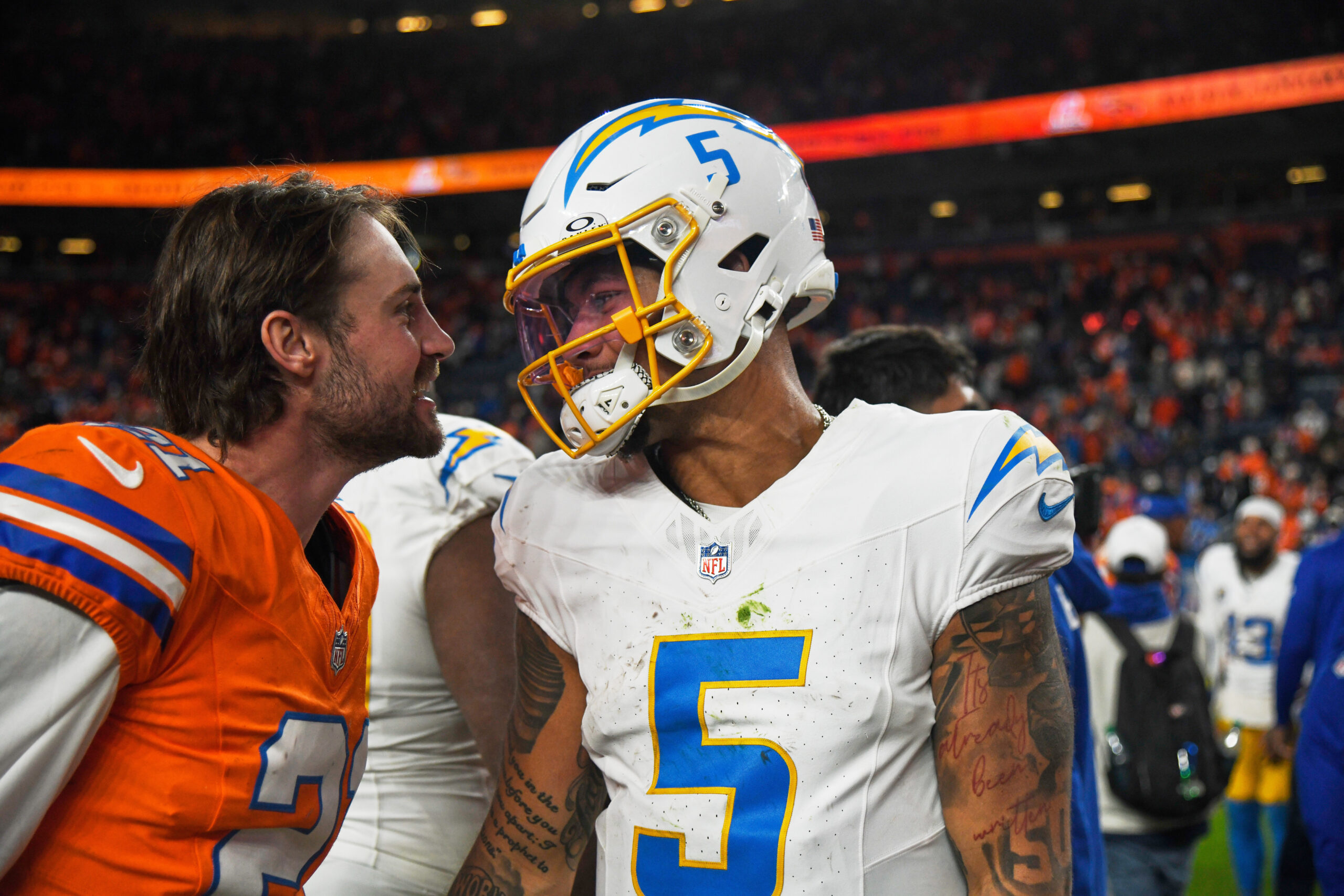 Chargers quarterback Trey Lance, right, greets Denver Broncos cornerback Riley...