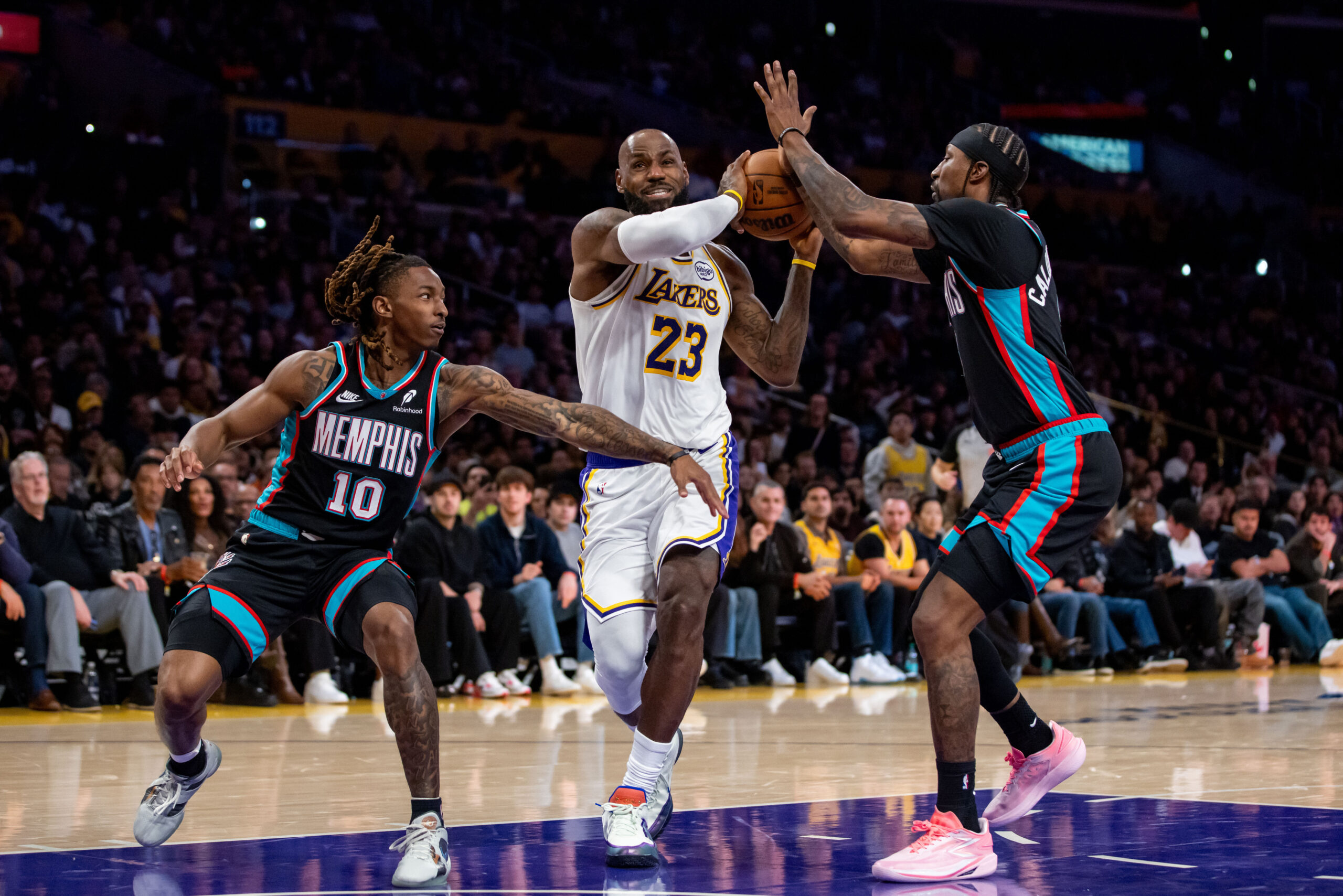 Lakers forward LeBron James (23) drives to the basket against...