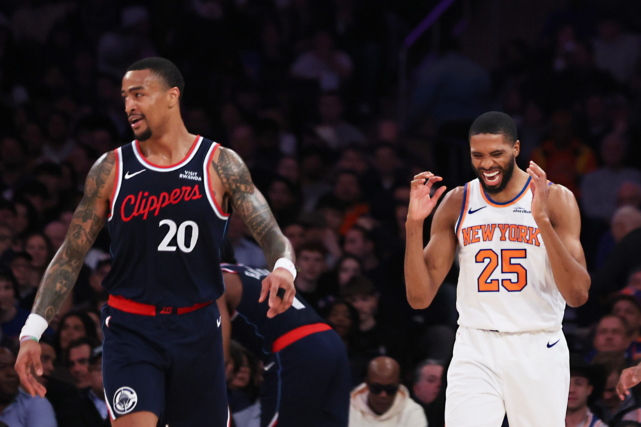 New York Knicks guard Mikal Bridges, right, reacts after a...