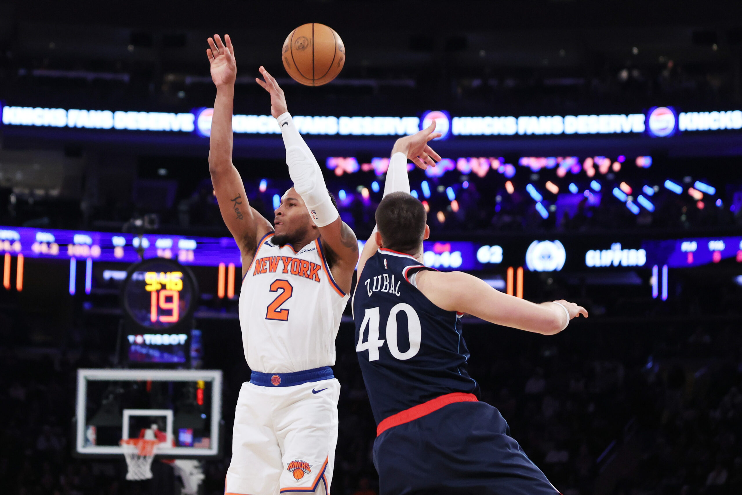 Clippers center Ivica Zubac, right, knocks the ball away from...