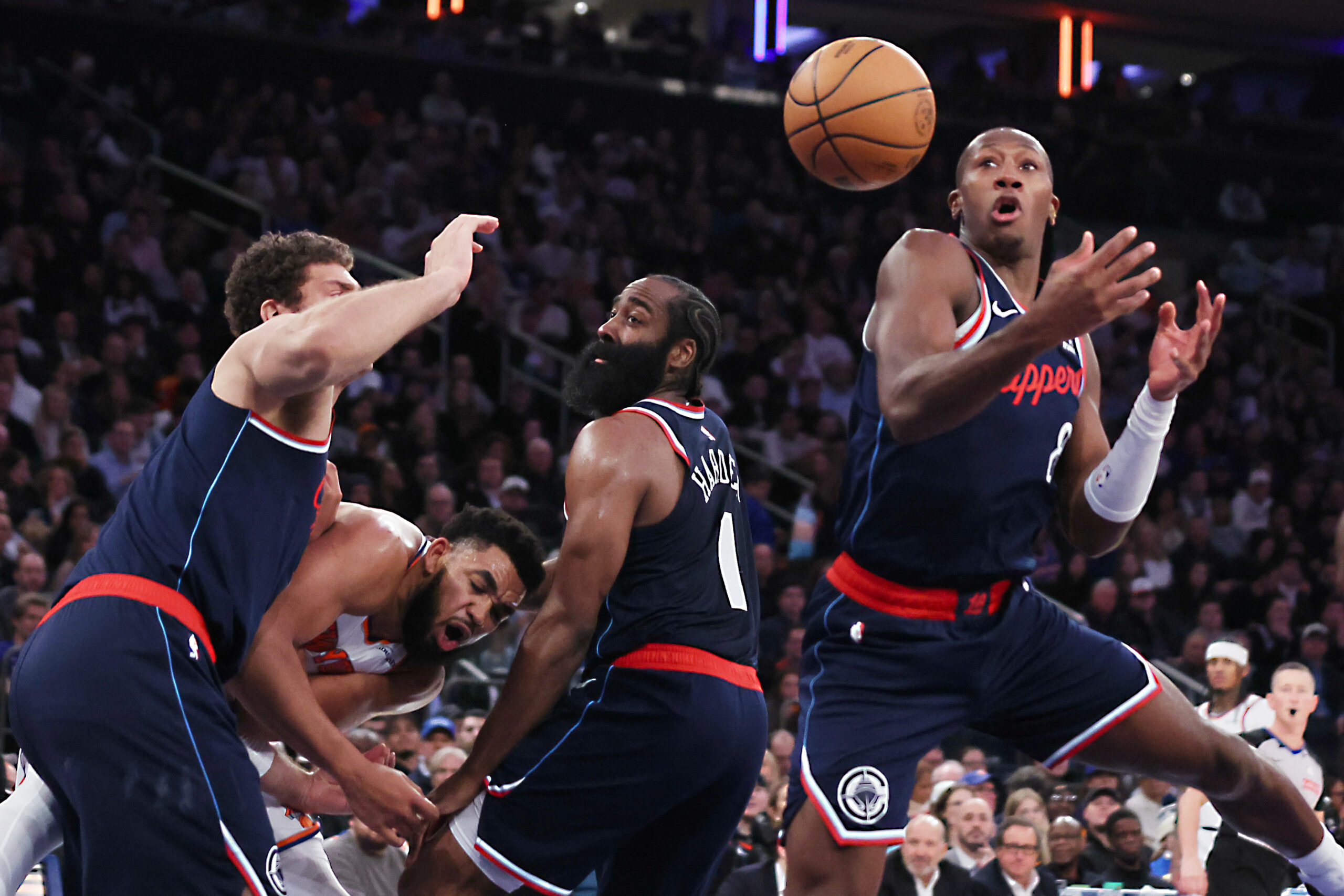Clippers guard Kris Dunn, right, goes up for a rebound...