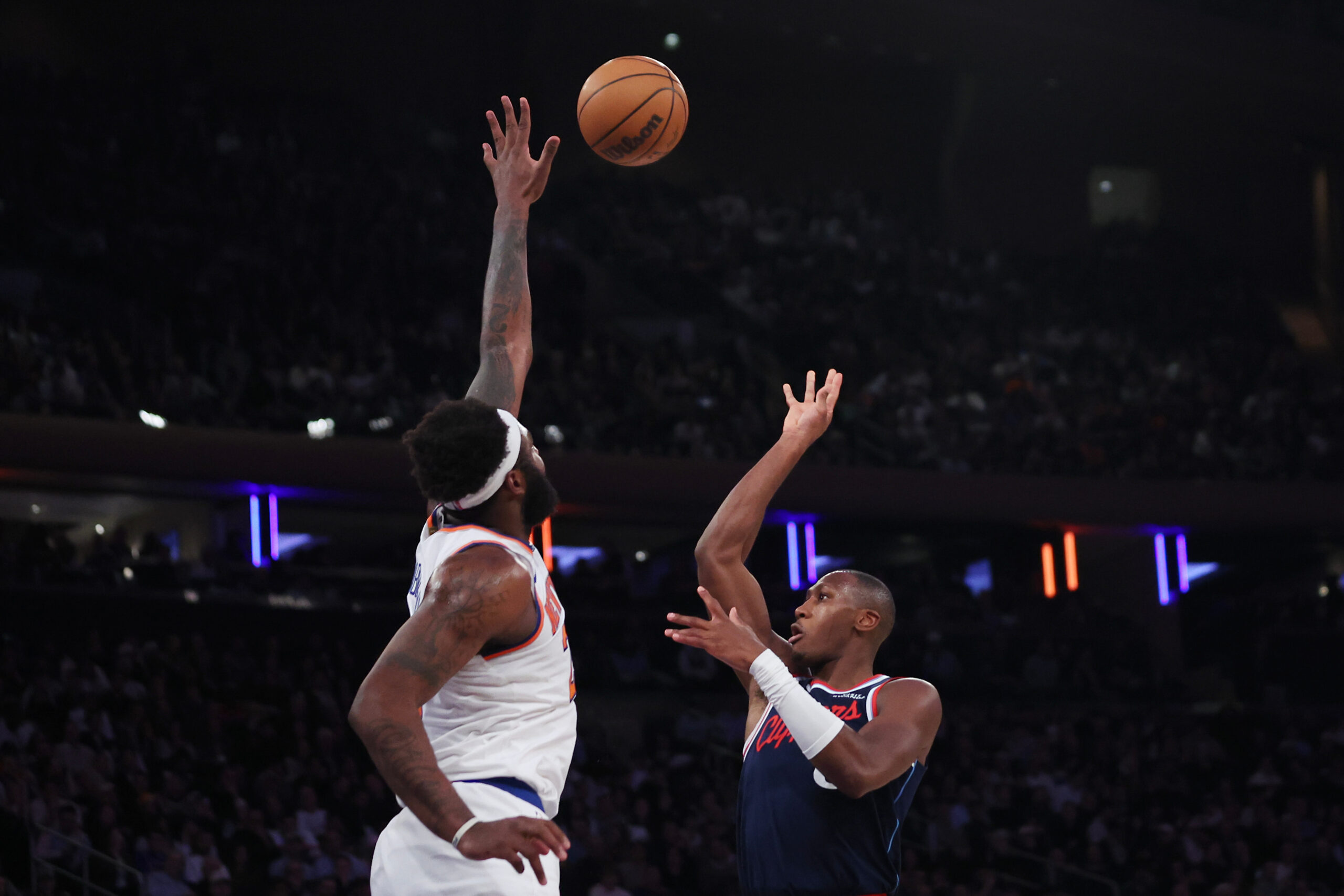 Clippers guard Kris Dunn, right, takes a shot as New...