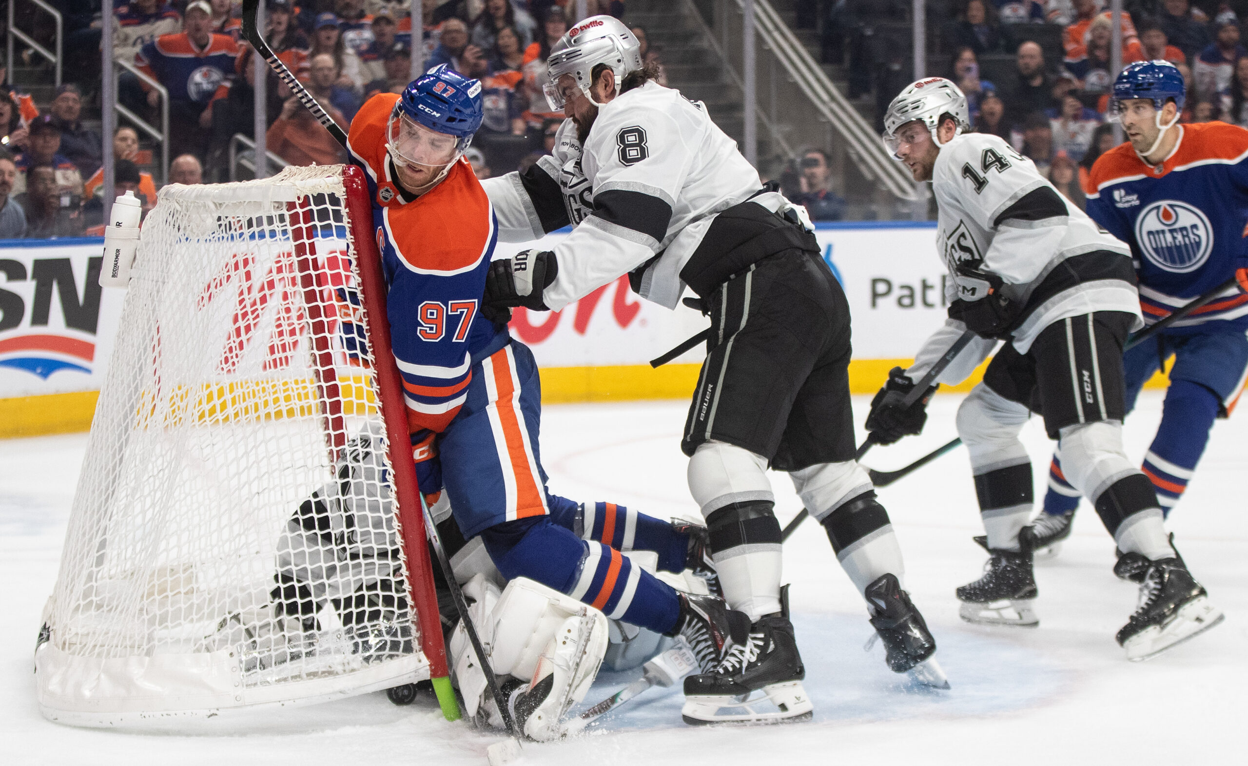 Kings’ Drew Doughty (8) checks Edmonton Oilers’ Connor McDavid (97)...