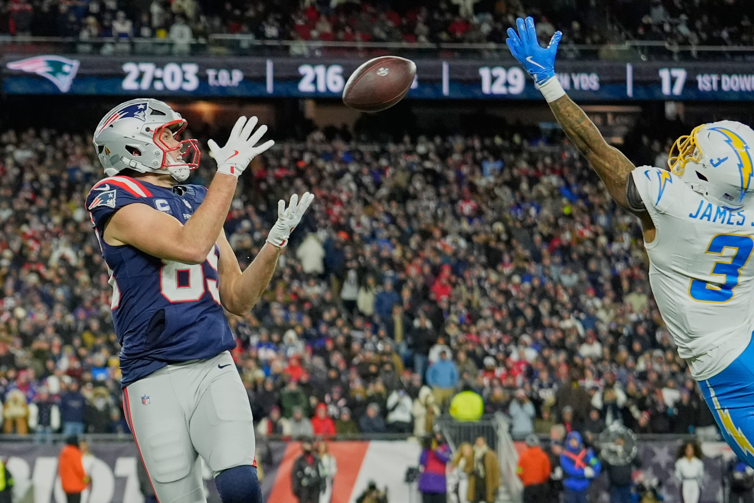 New England Patriots tight end Hunter Henry, left, catches a...
