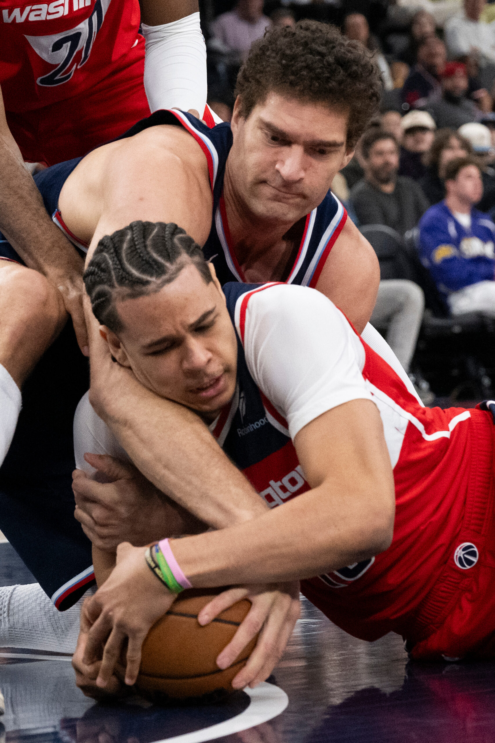 Washington Wizards forward Kyshawn George, bottom, and Clippers center Brook...