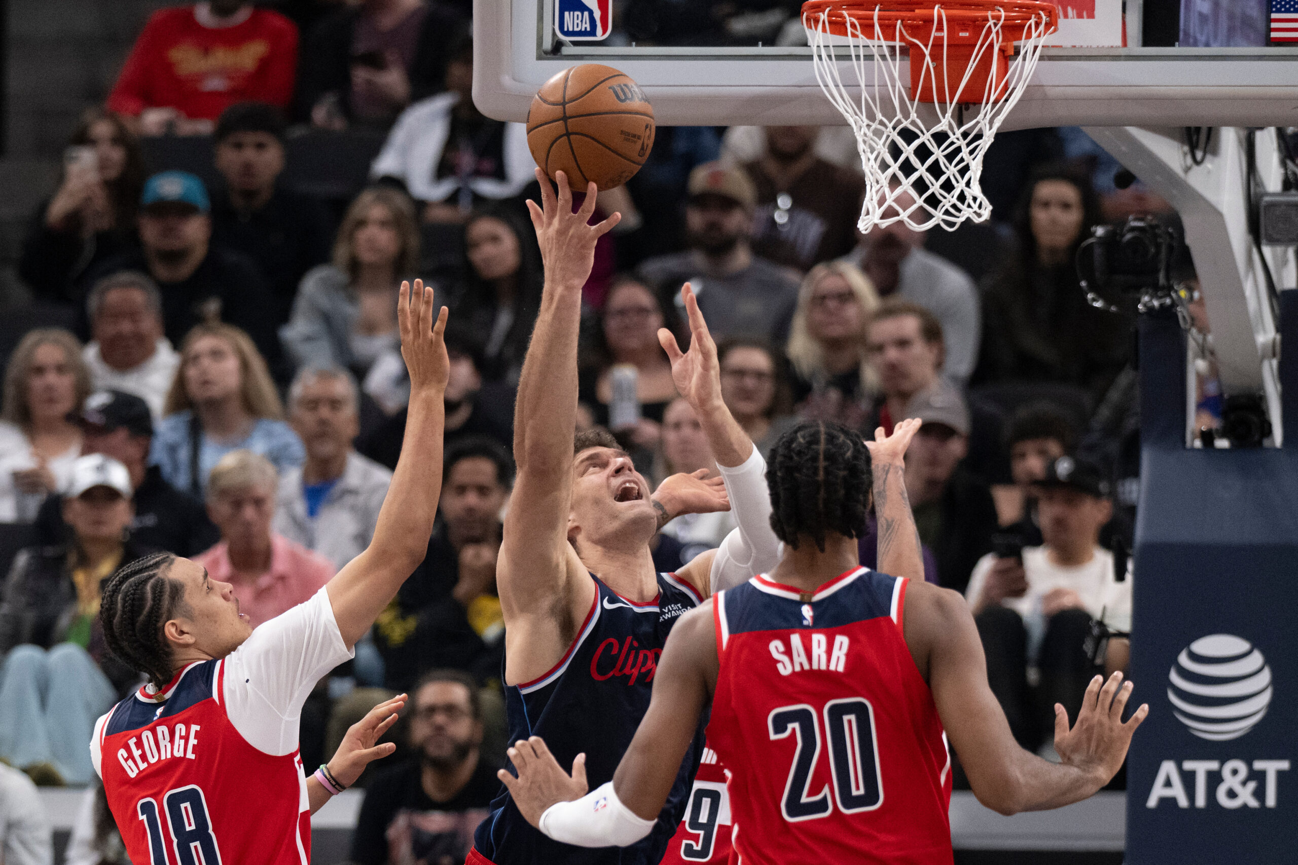 Clippers center Brook Lopez, center, shoots in front of Washington...
