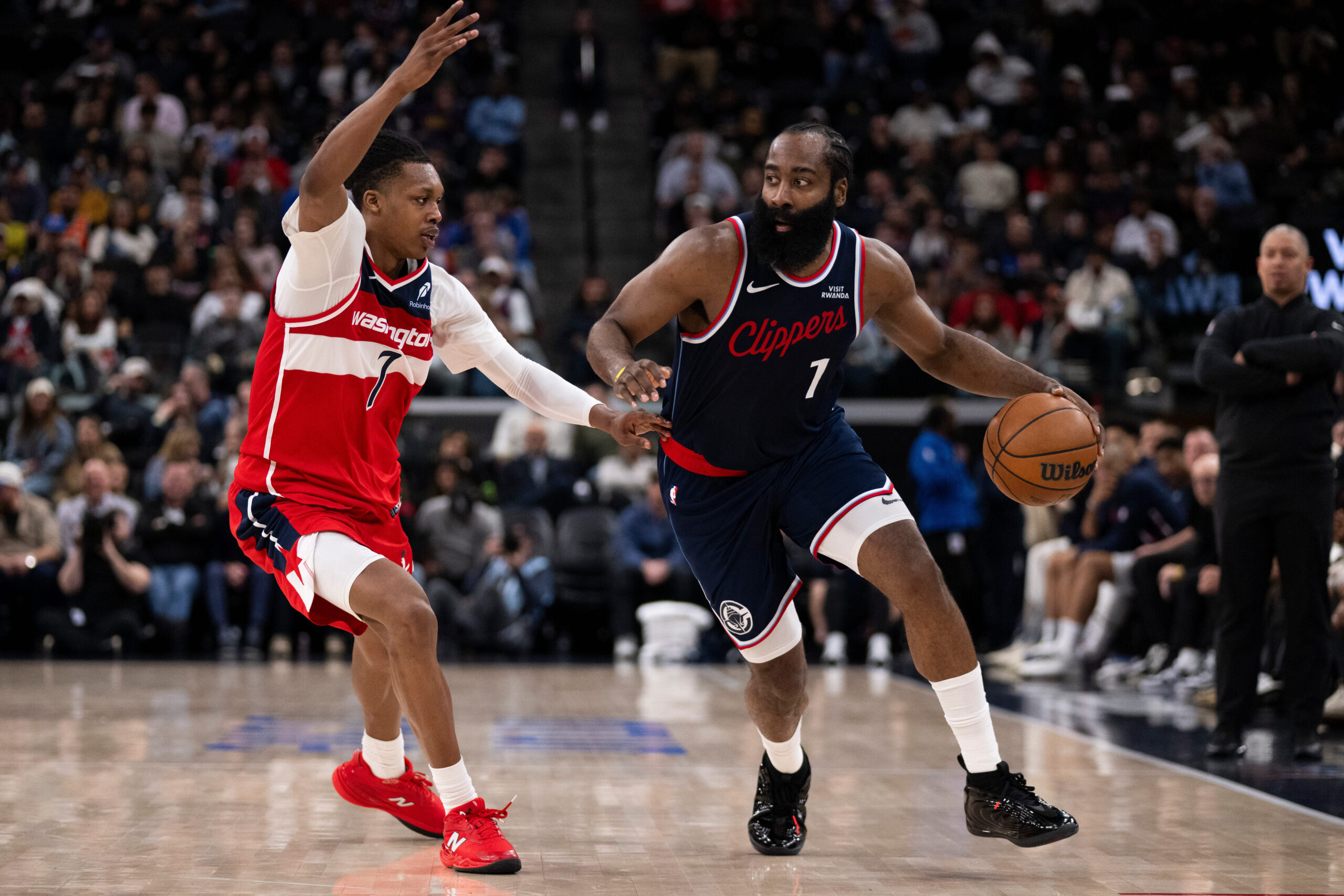 Clippers guard James Harden drives to the basket as Washington...