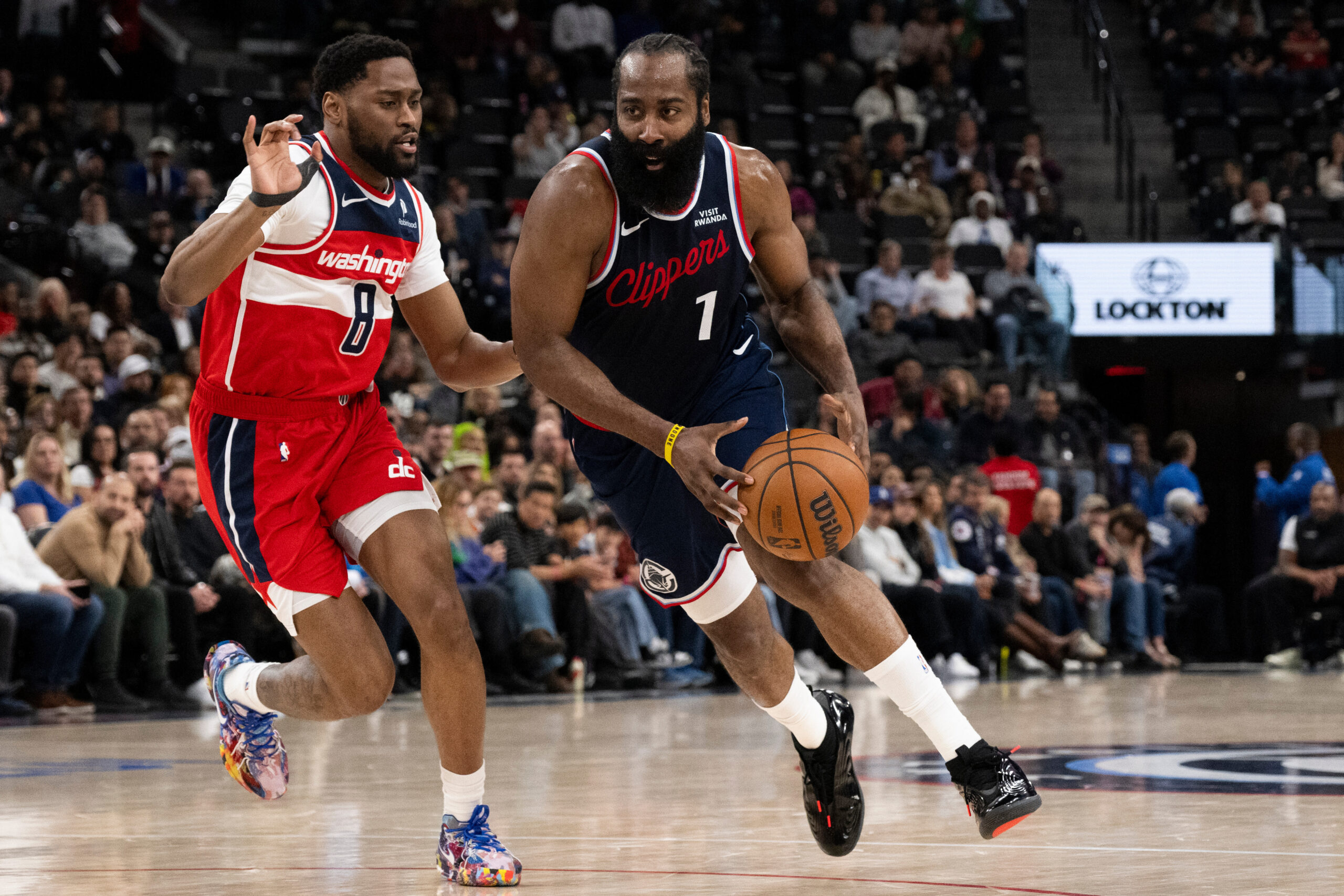 Clippers guard James Harden drives to the basket as Washington...