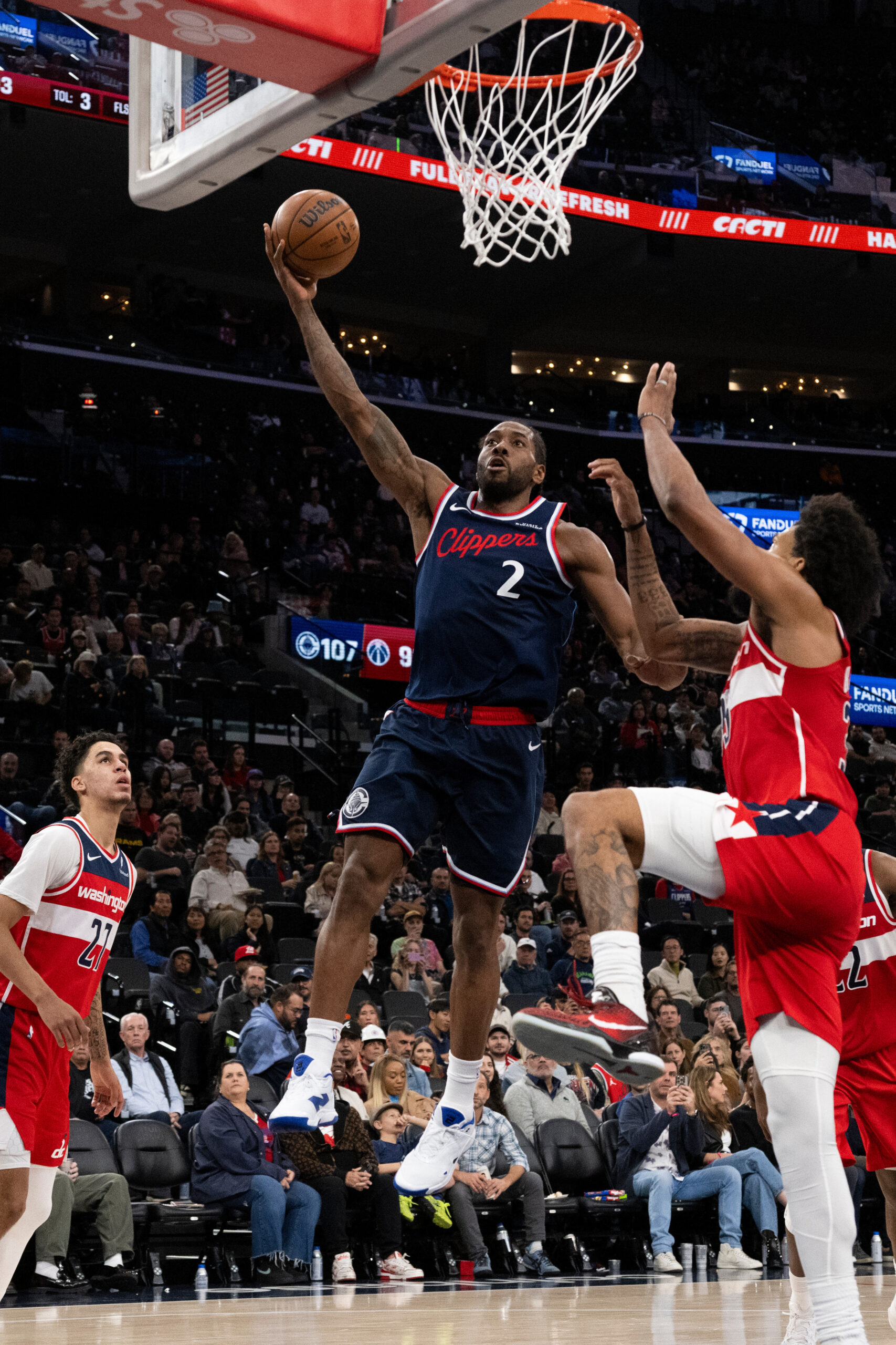 Clippers star Kawhi Leonard gets to the basket for a...