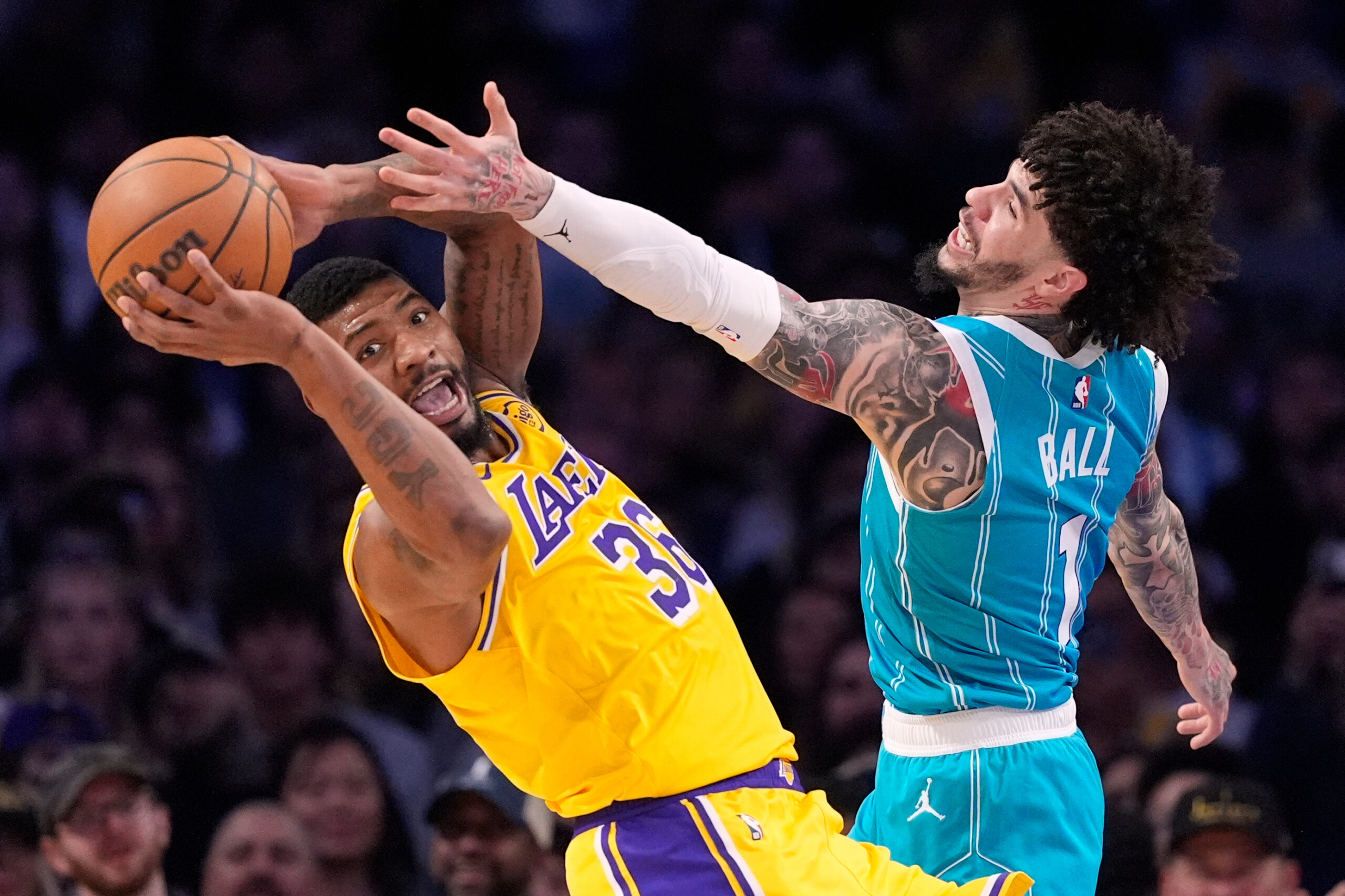 Lakers guard Marcus Smart, left, grabs a rebound away from...