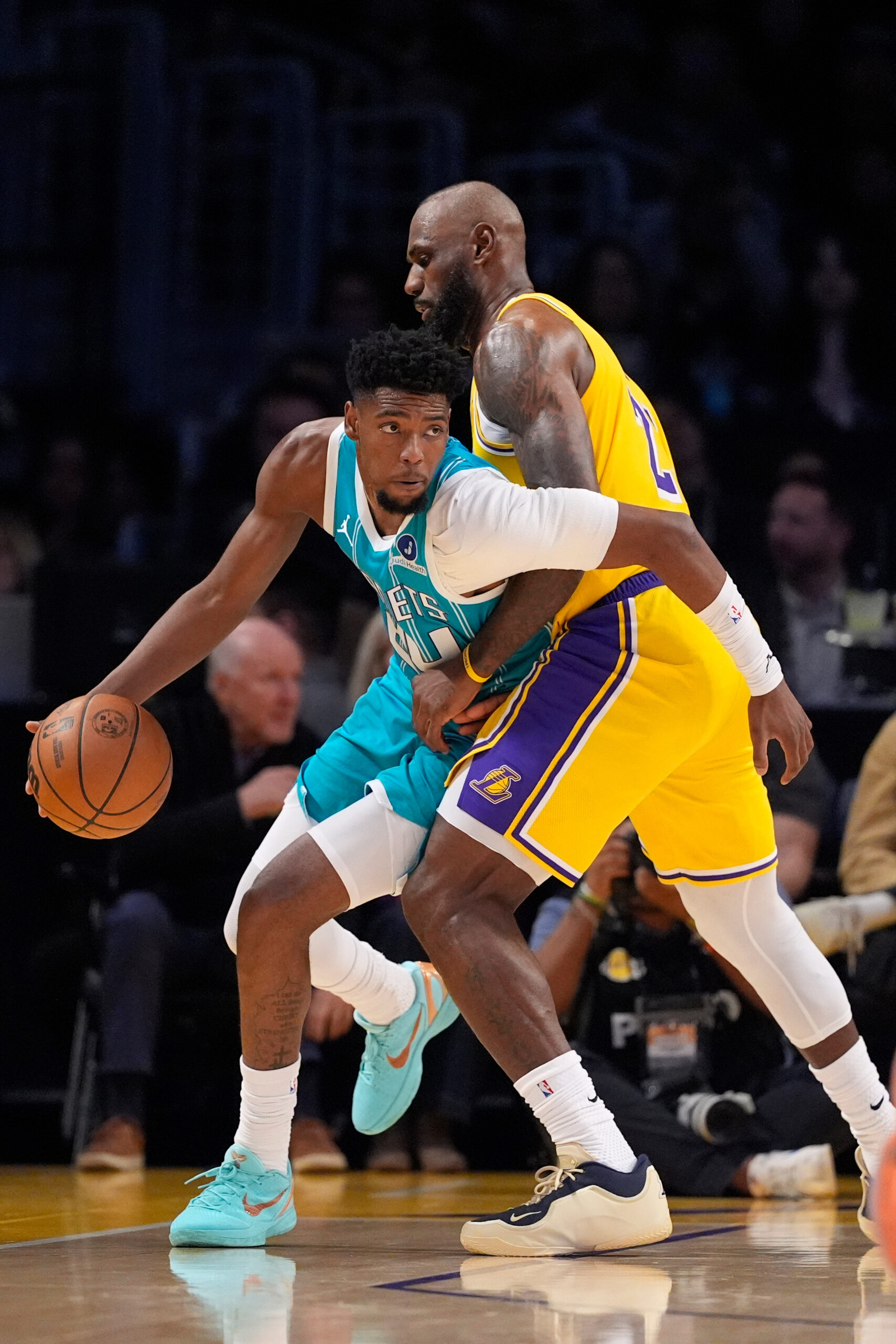 Charlotte Hornets forward Brandon Miller, left, tries to get around...