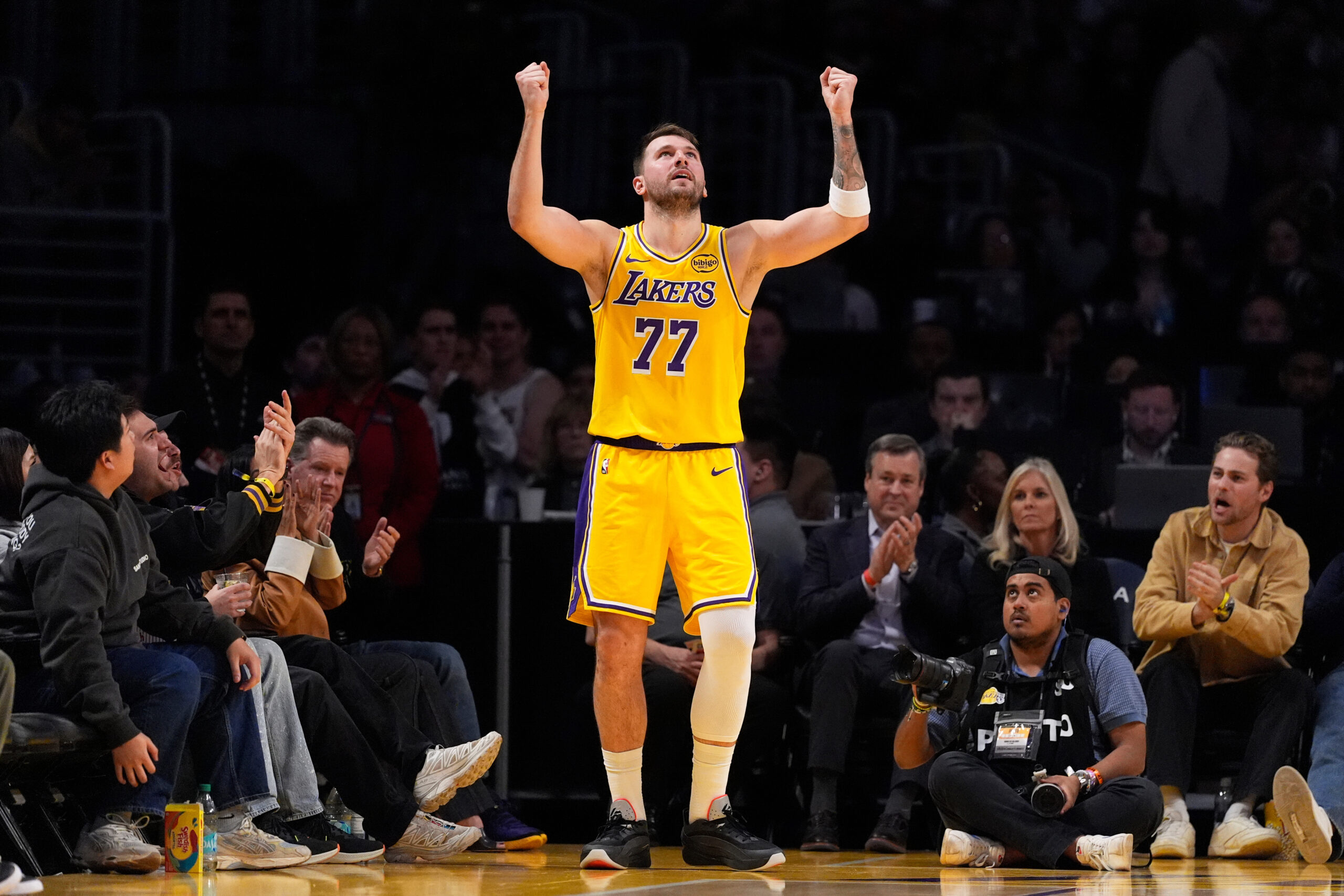Lakers guard Luka Doncic celebrates after scoring and drawing a...