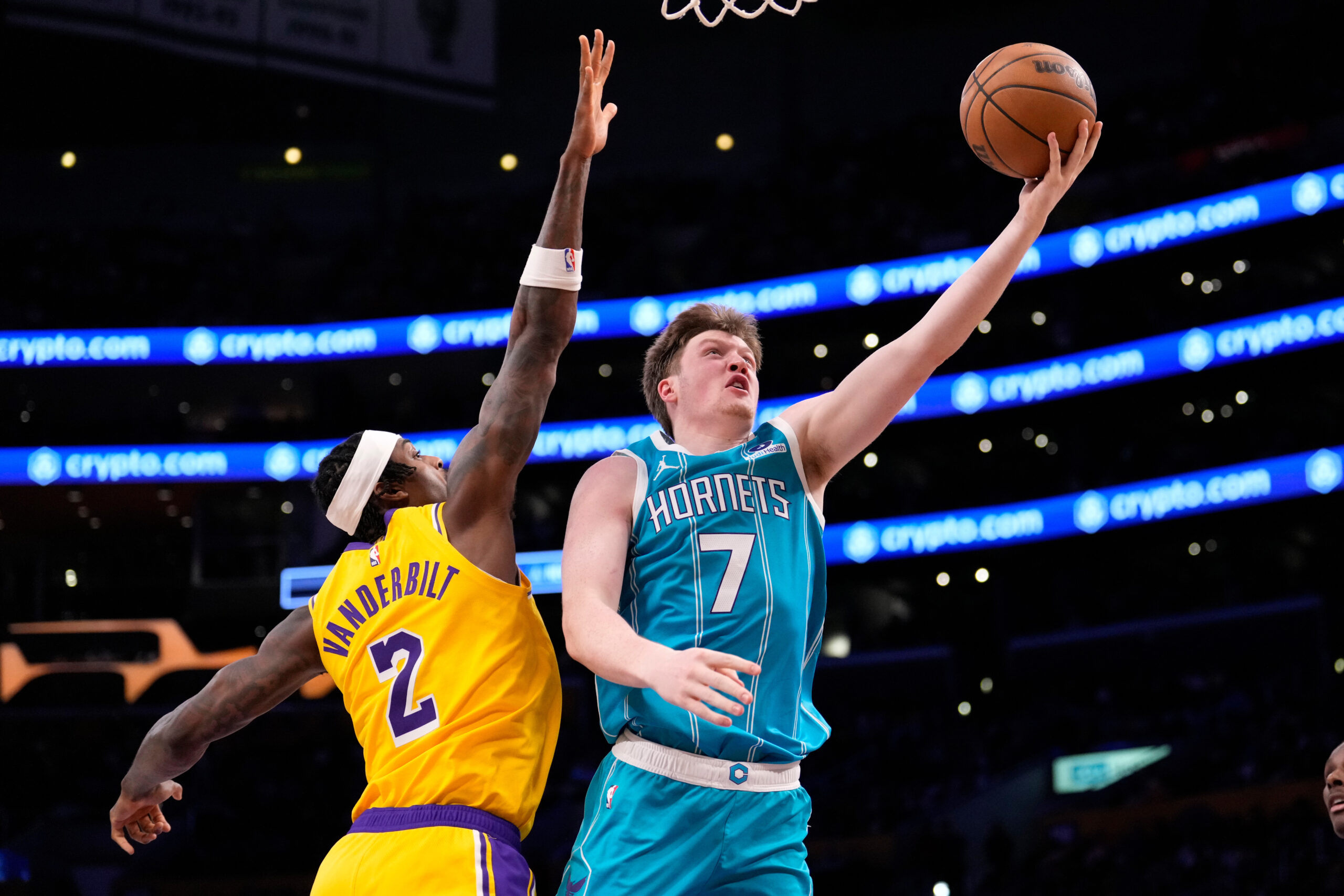 Charlotte Hornets guard Kon Knueppel, right, shoots as Lakers forward...