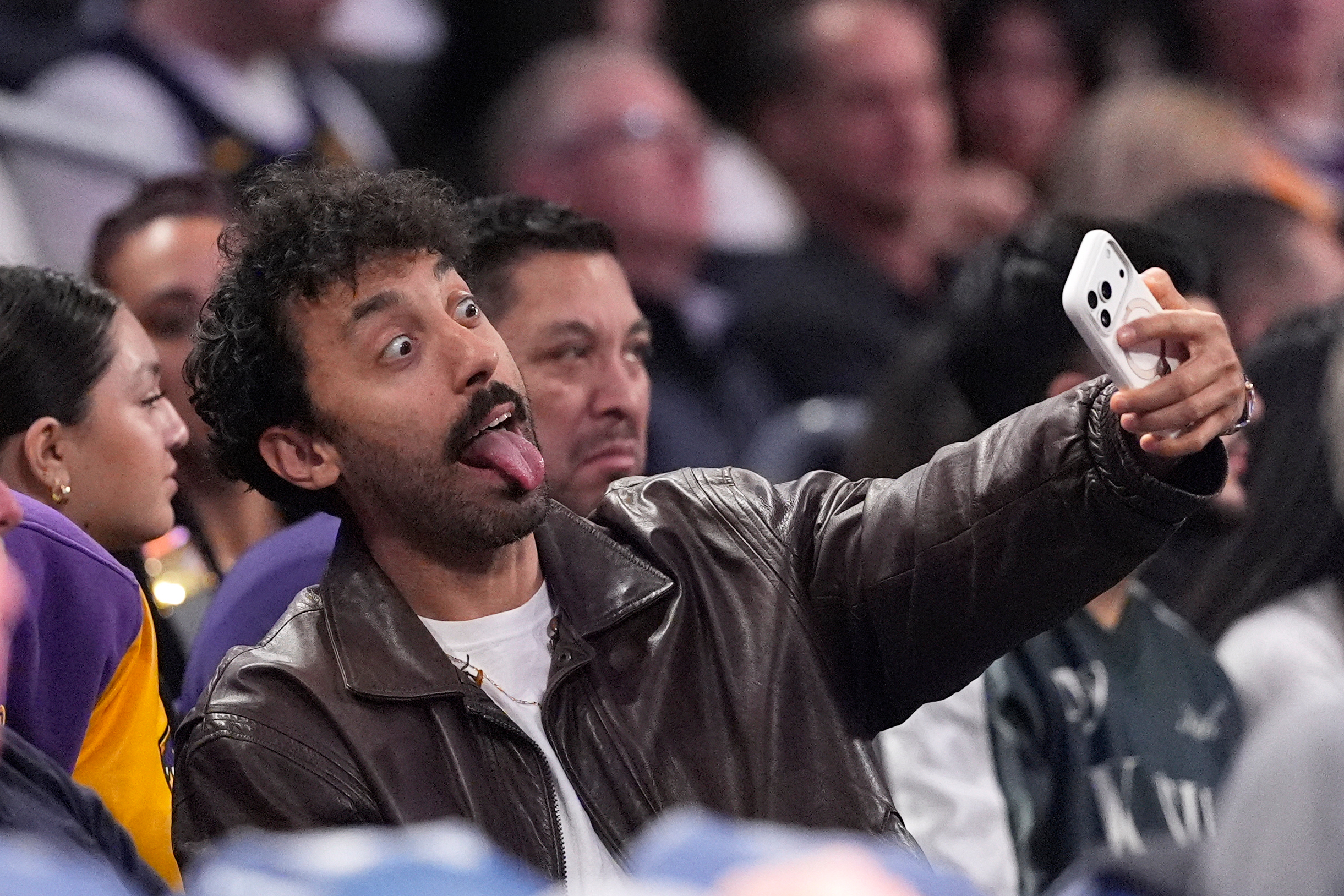 Comedian Morgan Jay takes a selfie with a fan during...
