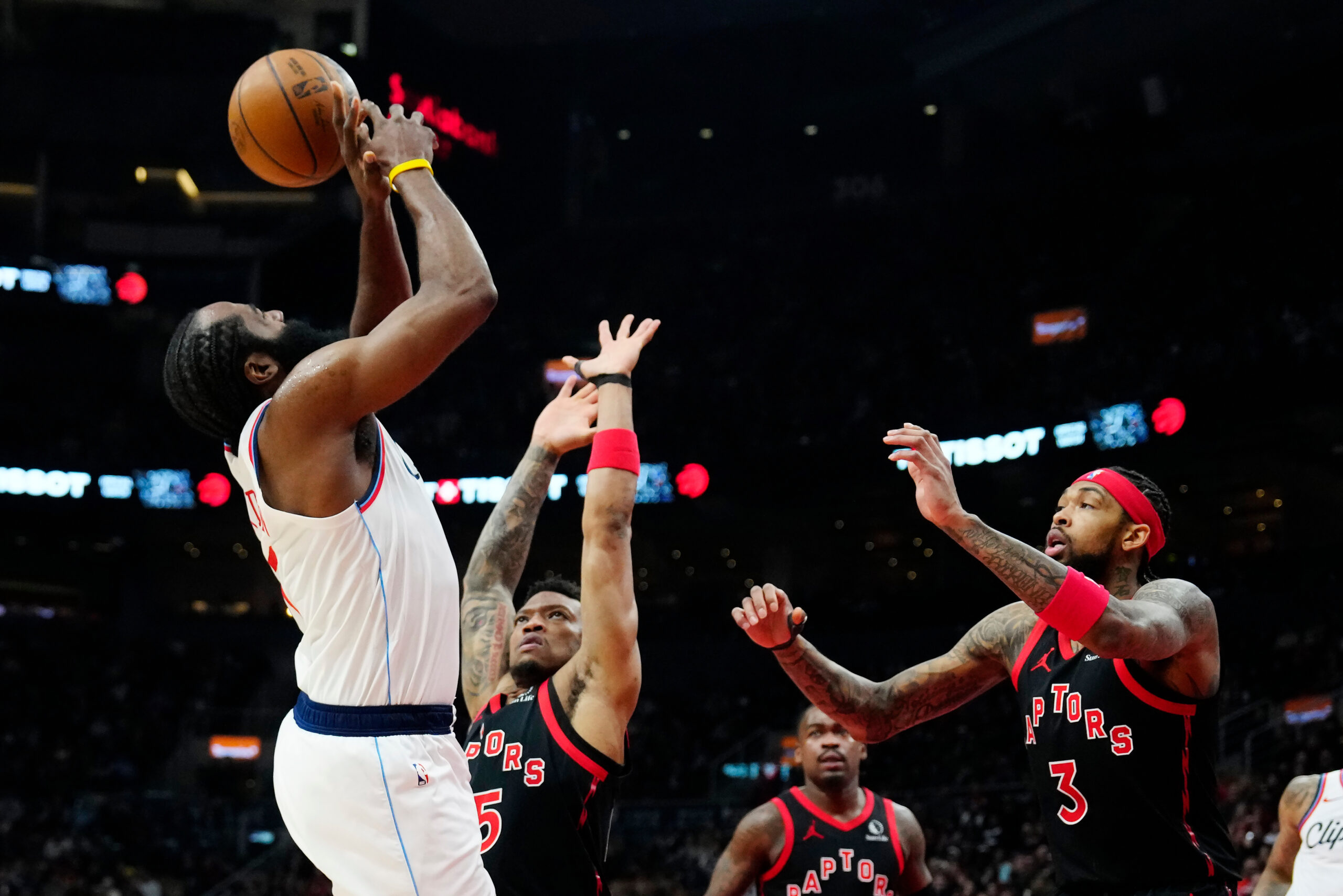 Clippers star James Harden, left, is fouled as the Toronto...