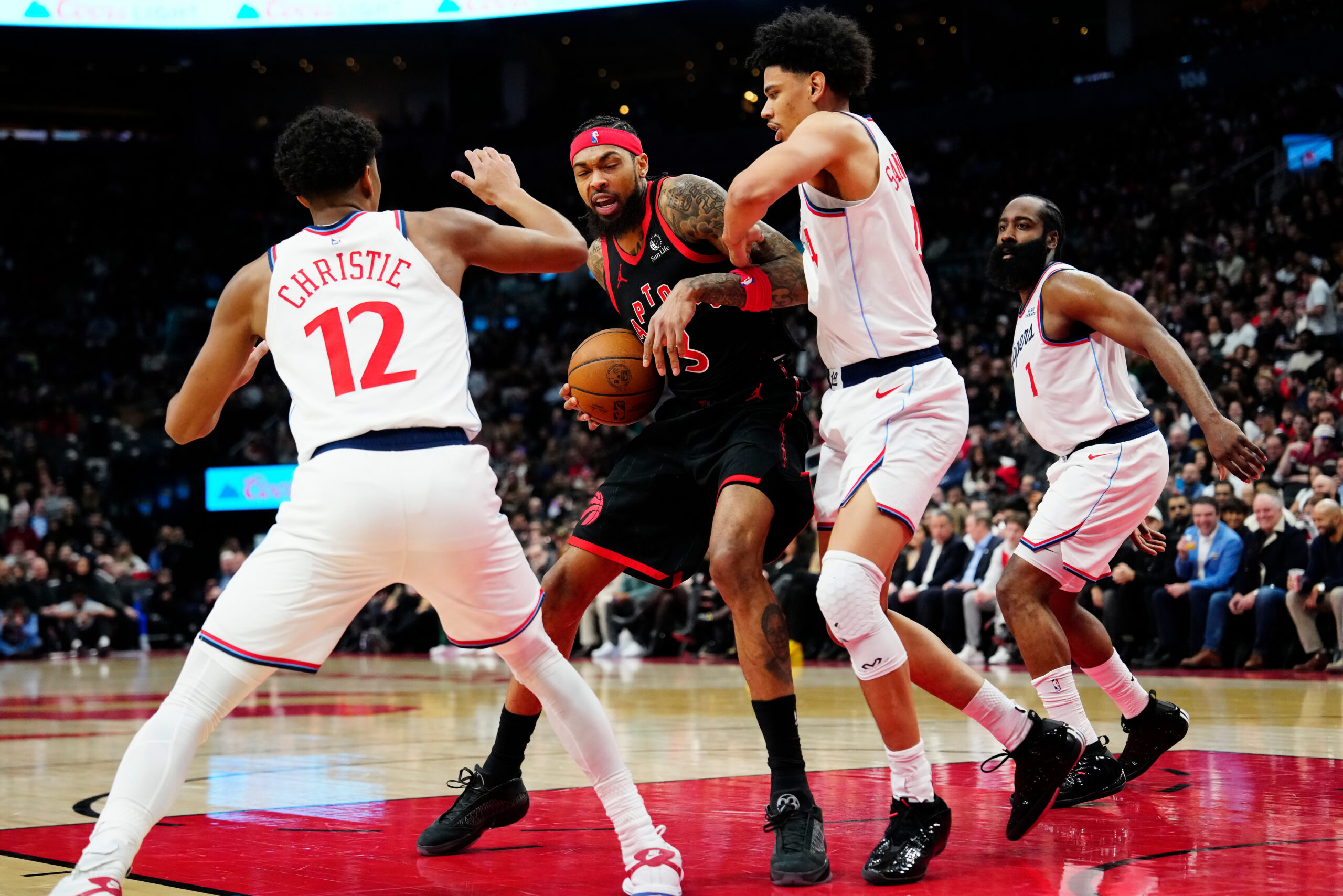 The Toronto Raptors’ Brandon Ingram, center, battles with the Clippers’...