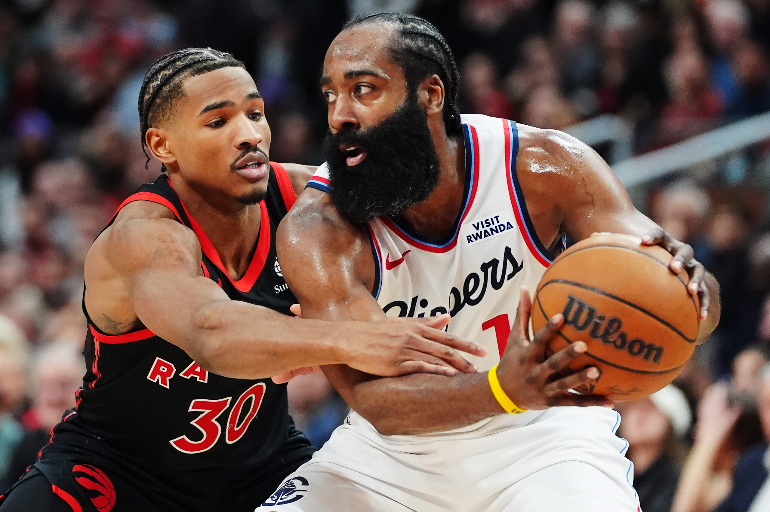 Los Angeles Clippers’ James Harden, right, protects the ball from...