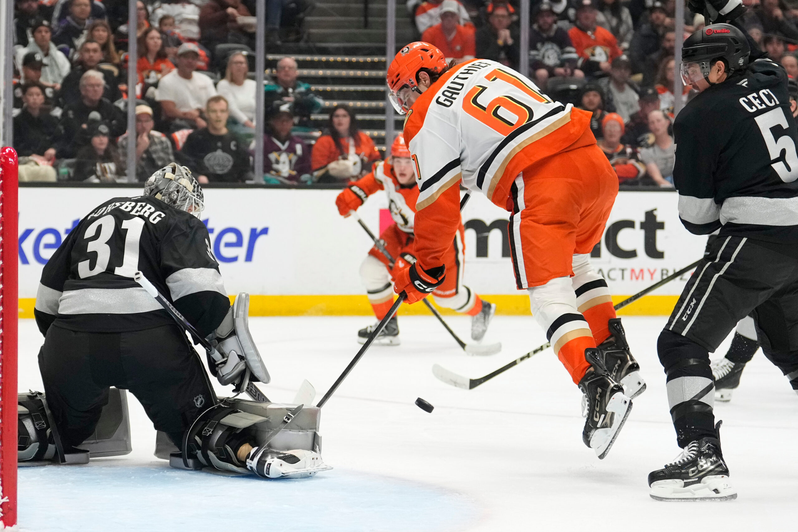 Kings goaltender Anton Forsberg, left, stops a shot as Ducks...