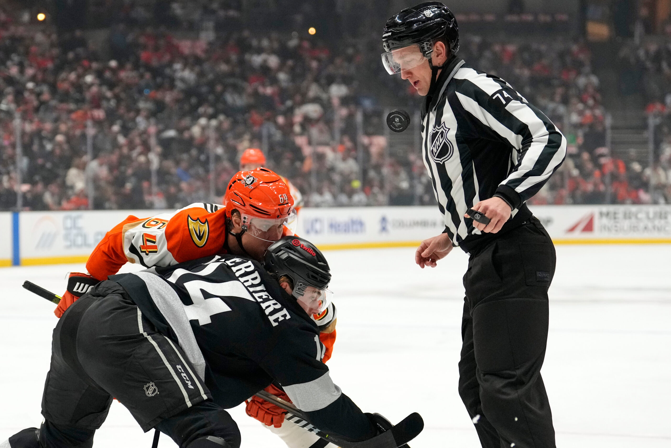 Linesman Trent Knorr, right, jumps out of the way of...
