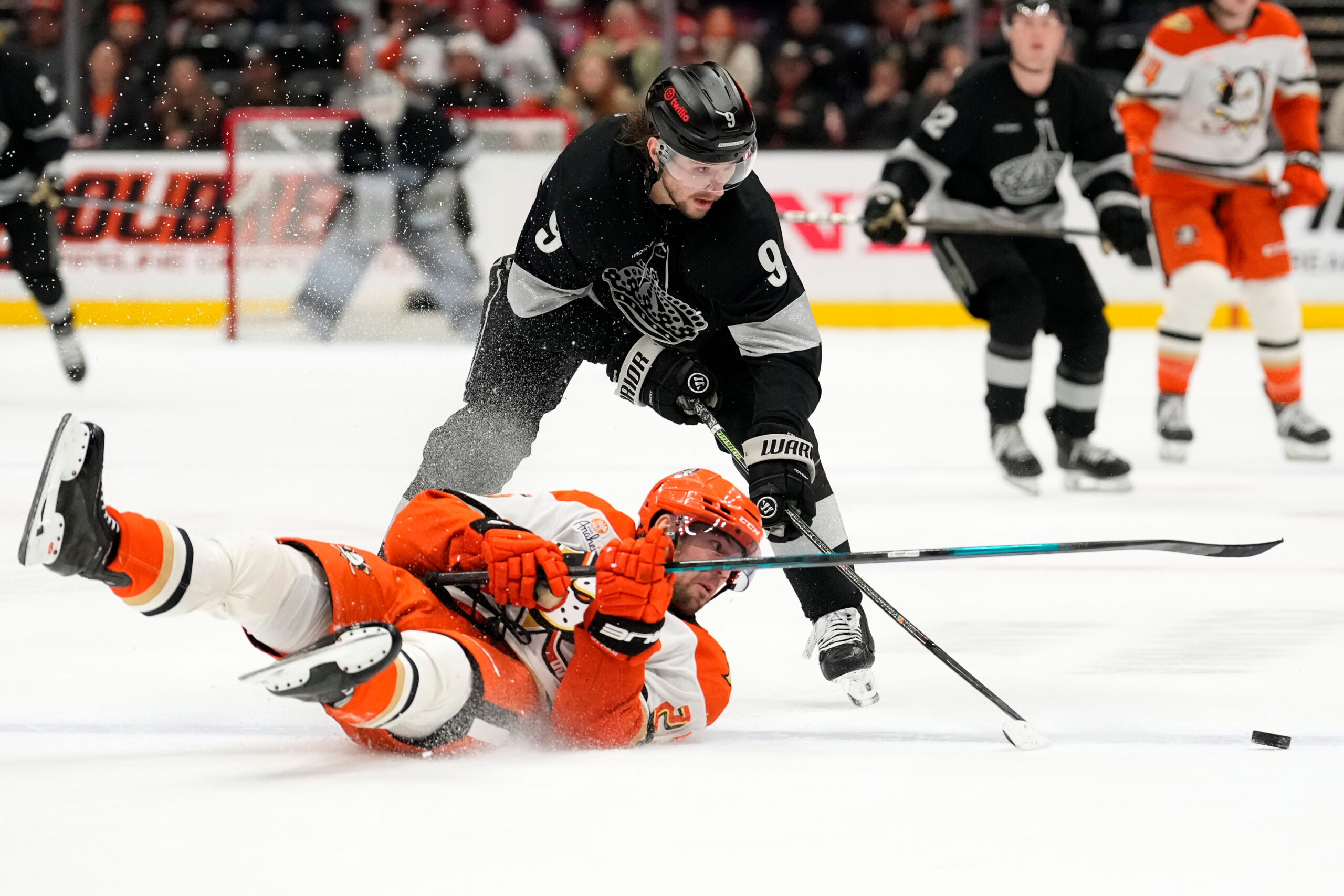 Ducks center Ryan Poehling, left, falls as Kings right wing...