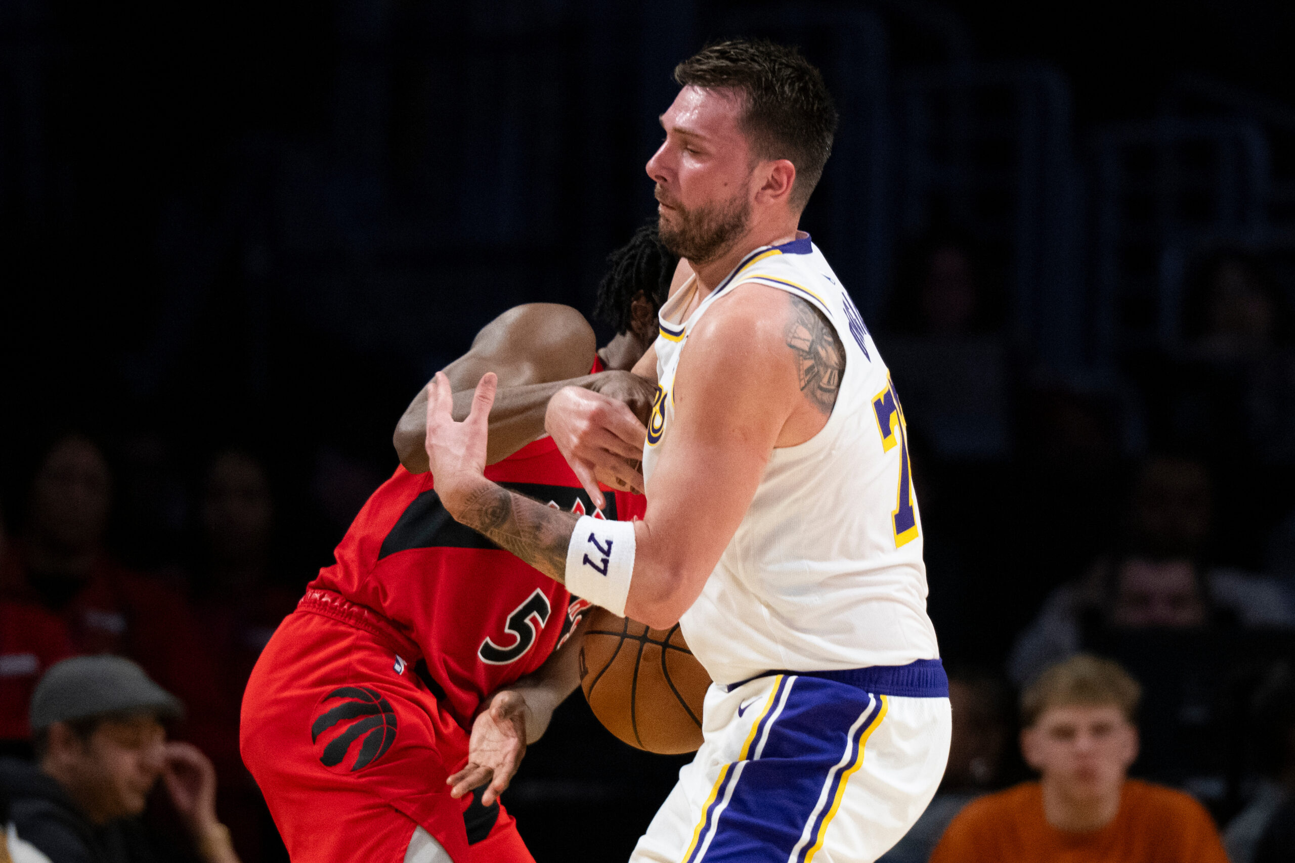 Lakers guard Luka Doncic (77) and Toronto Raptors guard Immanuel...