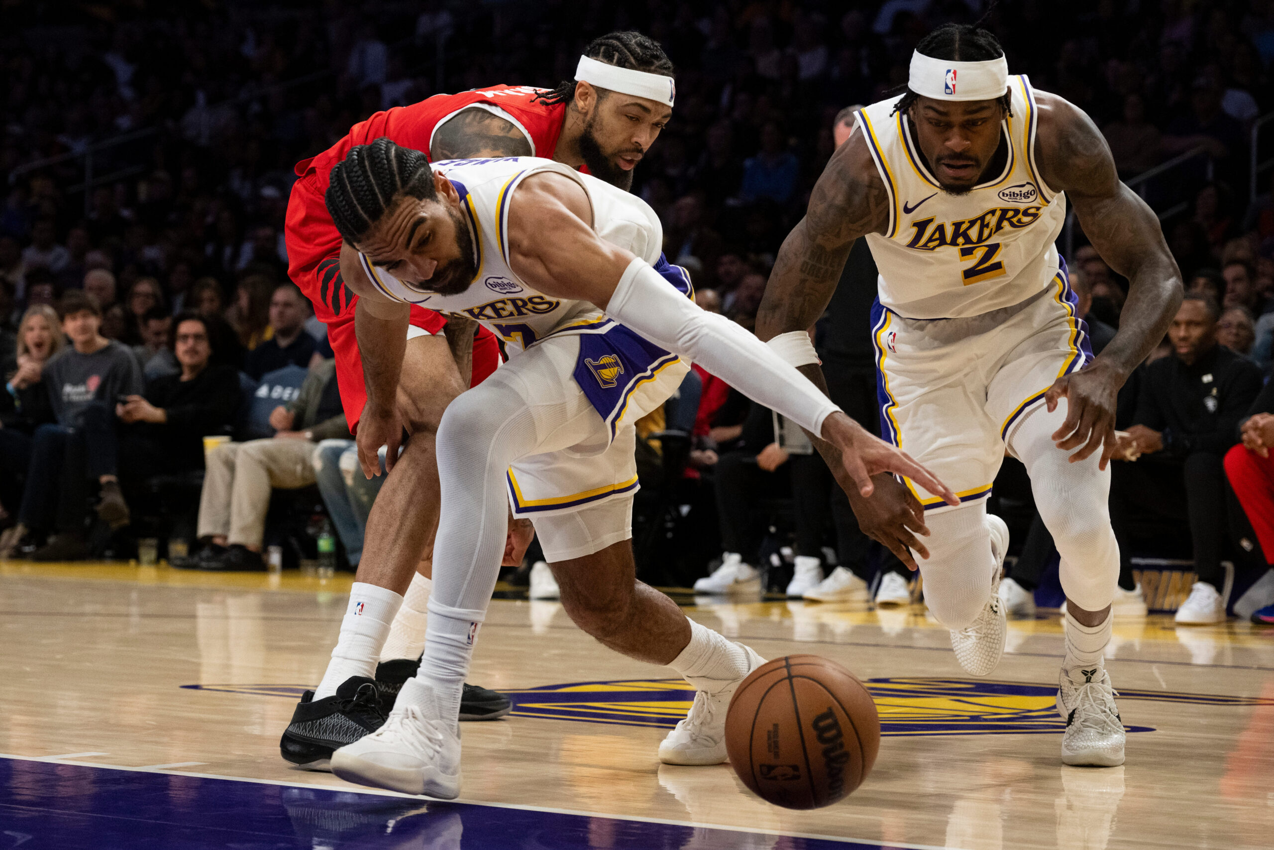 Lakers guard Gabe Vincent, front, steals the ball away from...