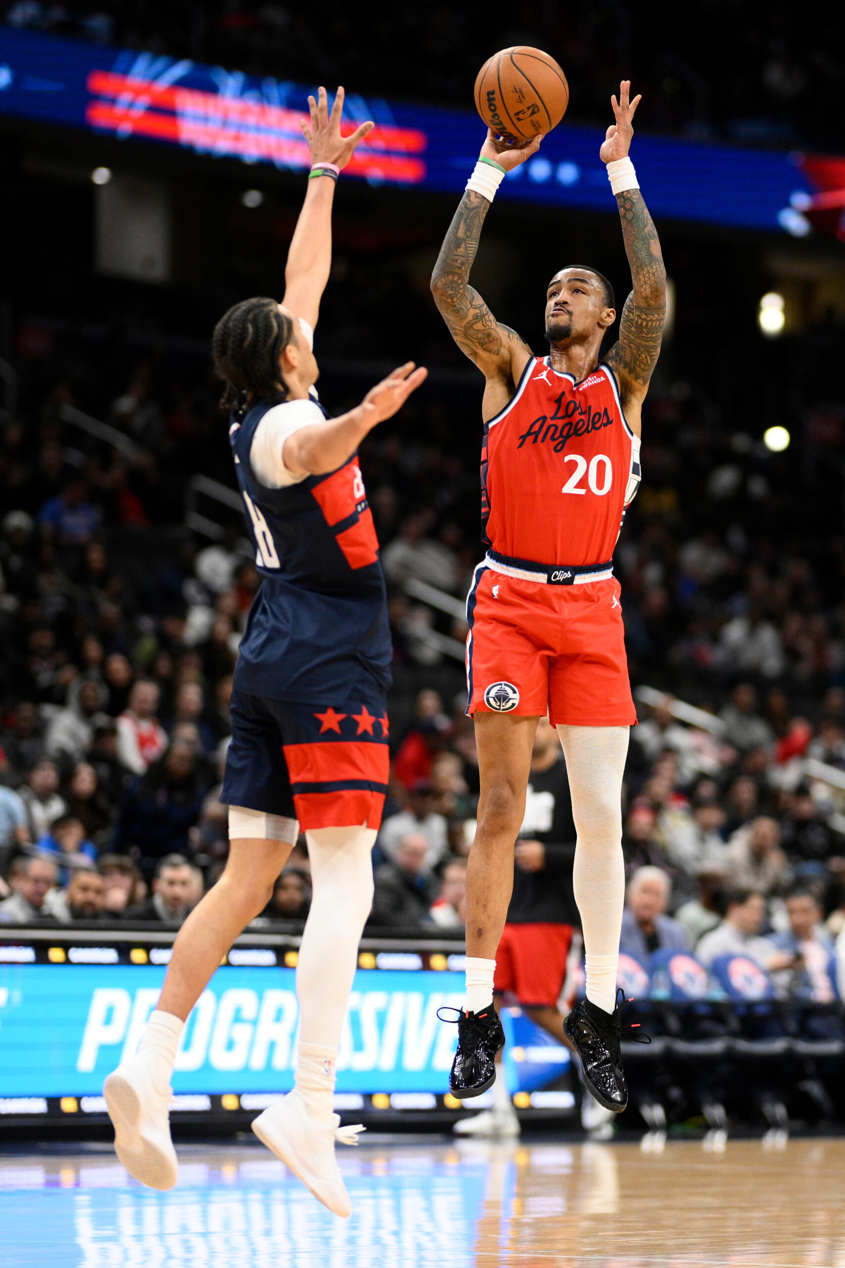 Clippers forward John Collins goes up to shoot as Washington...