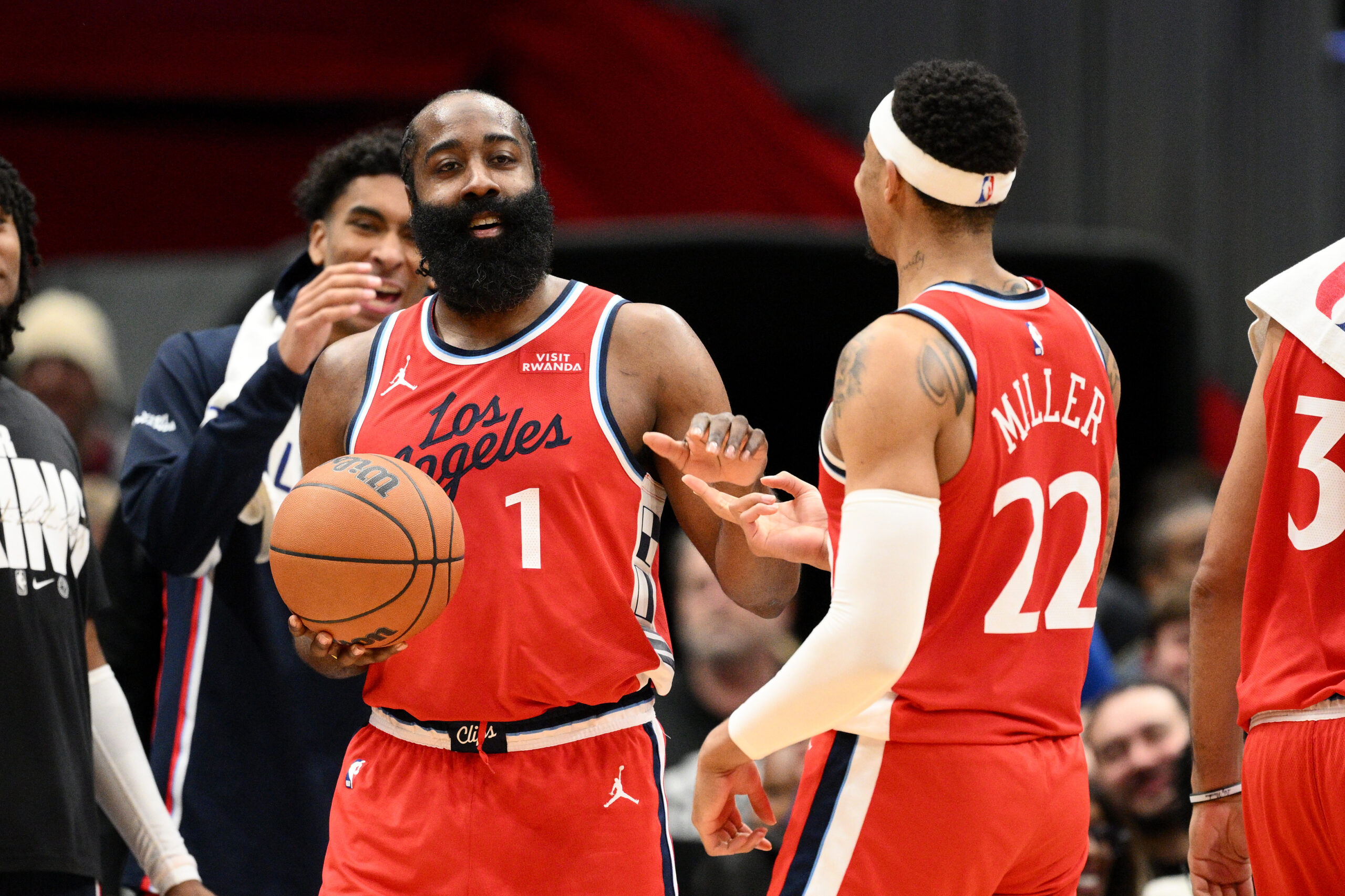 Clippers star James Harden, left, reacts with guard Jordan Miller...