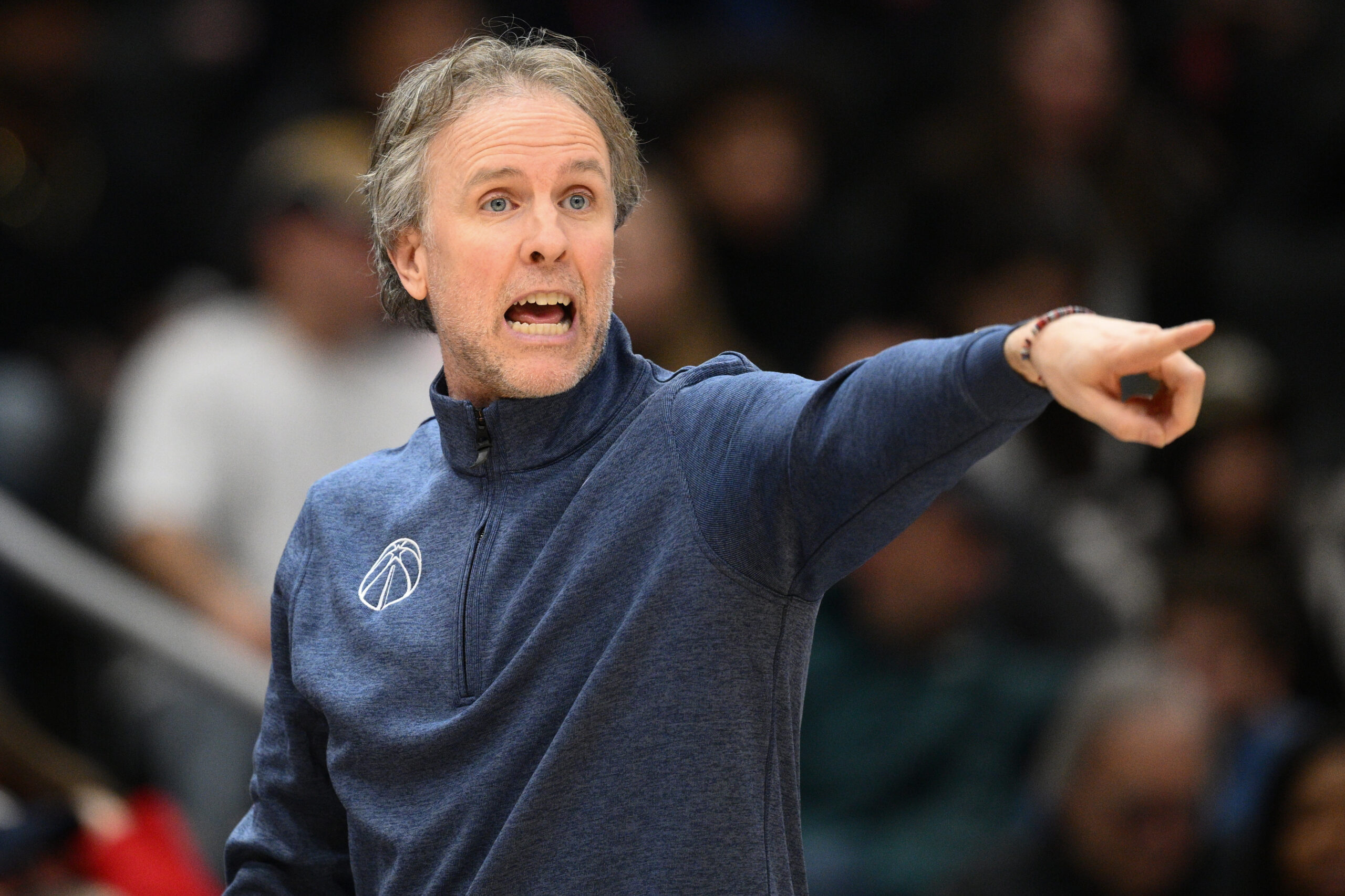 Washington Wizards head coach Brian Keefe points from the sideline...