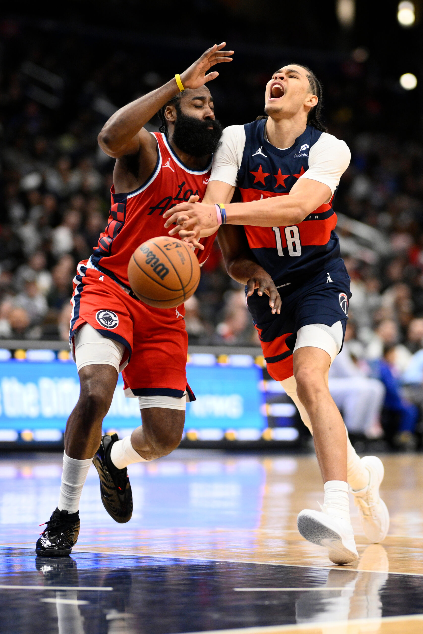 Washington Wizards forward Kyshawn George, right, loses the ball as...