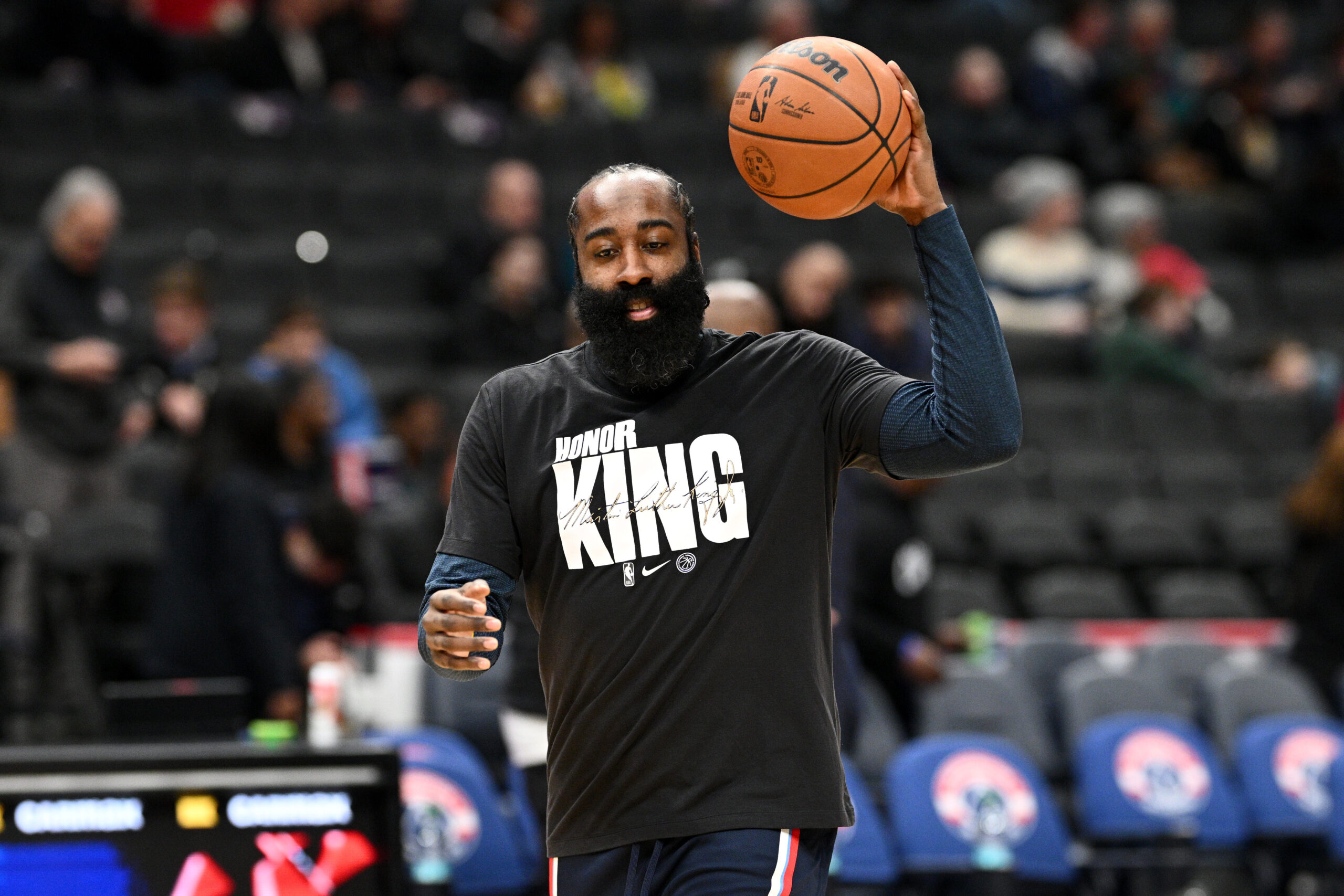 Clippers guard James Harden warms up while wearing a shirt...