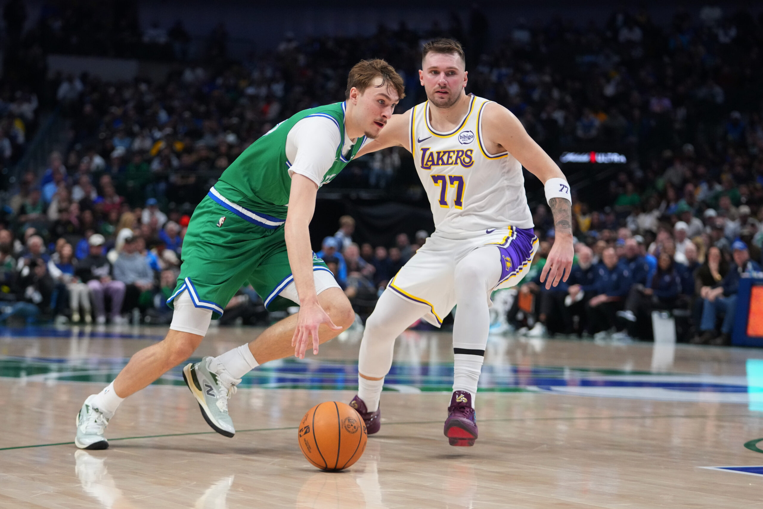 Dallas Mavericks forward Cooper Flagg, left, drives past Lakers guard...