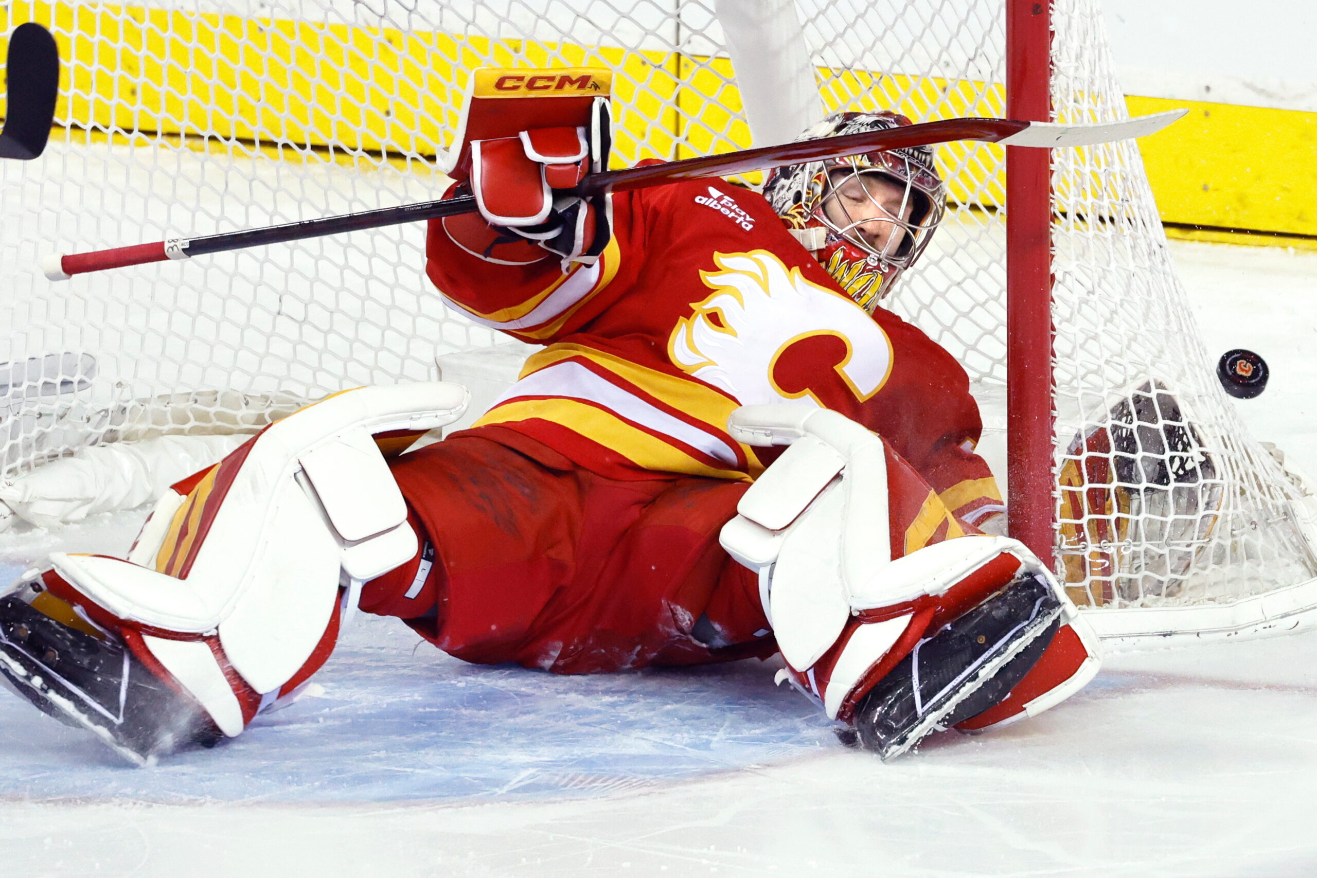 Calgary Flames goalie Dustin Wolf makes a save against the...