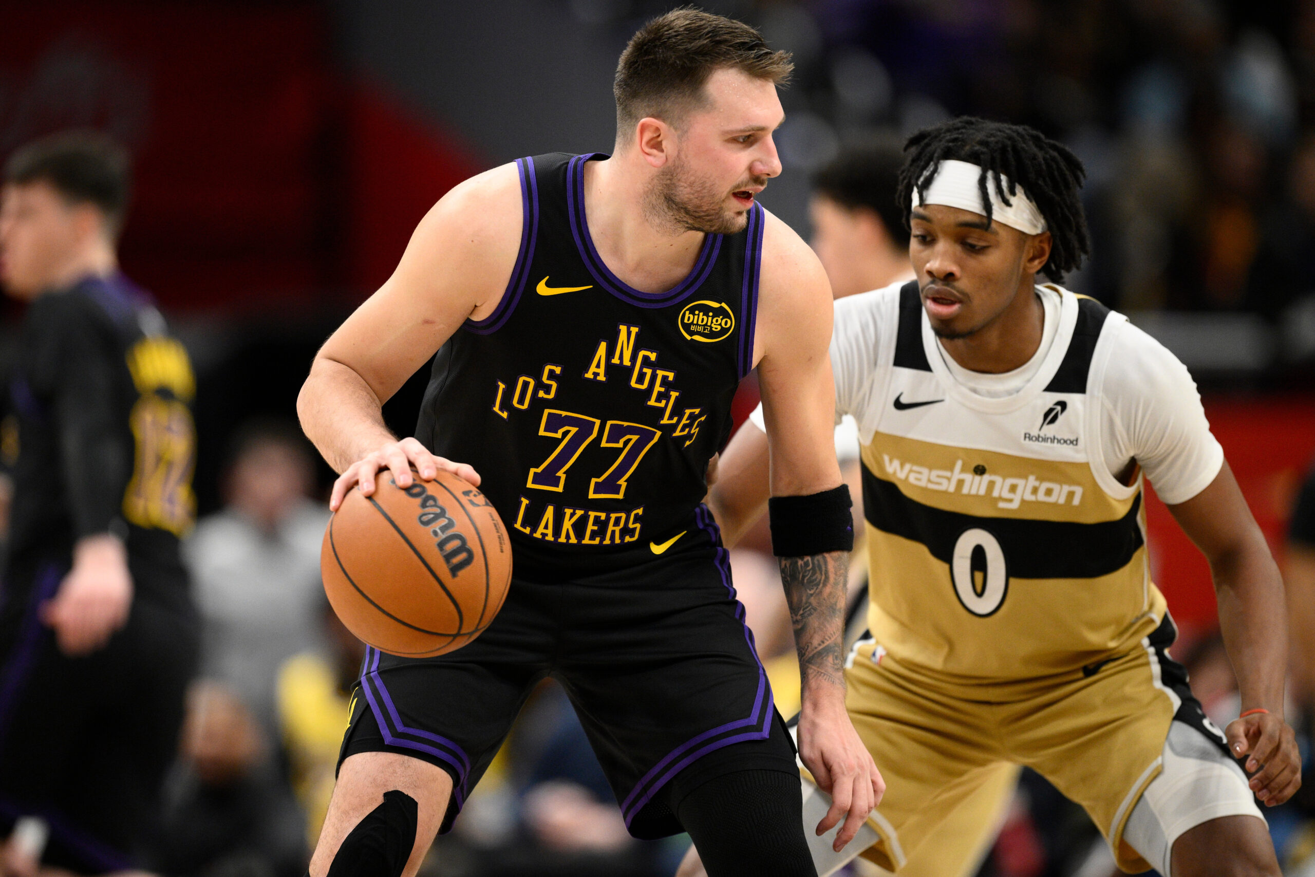 Lakers star Luka Doncic dribbles against Washington Wizards guard Bilal...